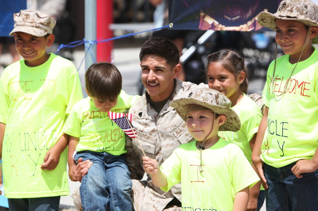Sergeant Jesse Garcia, a data network specialist deployed with 1st Marine Logistics Group, and a native of Los Angeles, is greeted by loved ones after returning from a deployment to Afghanistan during a welcome home aboard Camp Pendleton, Calif., June 8, 2013.