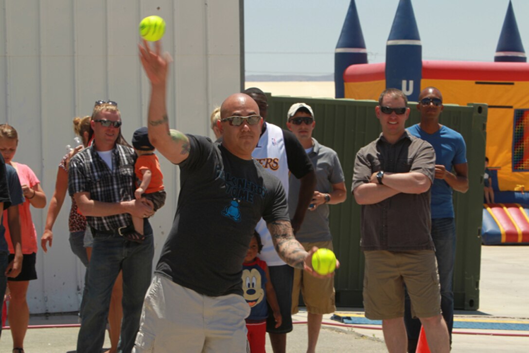 Staff Sgt. Richard Davenport, motor transportation staff noncommmissioned officer in charge, Support Company, 3rd Combat Engineer Battalion throws a ball at a dunk tank target during the unit’s family day event, May 23, 2013.