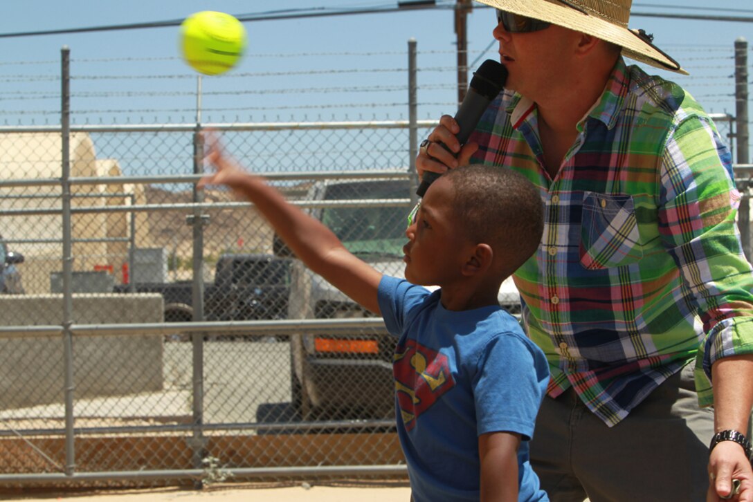 Gavin Natt, 3, son of Sgt. Kevin Natt, assistant administration chief, Headquarters and Services Company, 3rd Combat Engineer Battalion, throws a ball at a dunk tank target during the unit’s family day event, May 23, 2013.