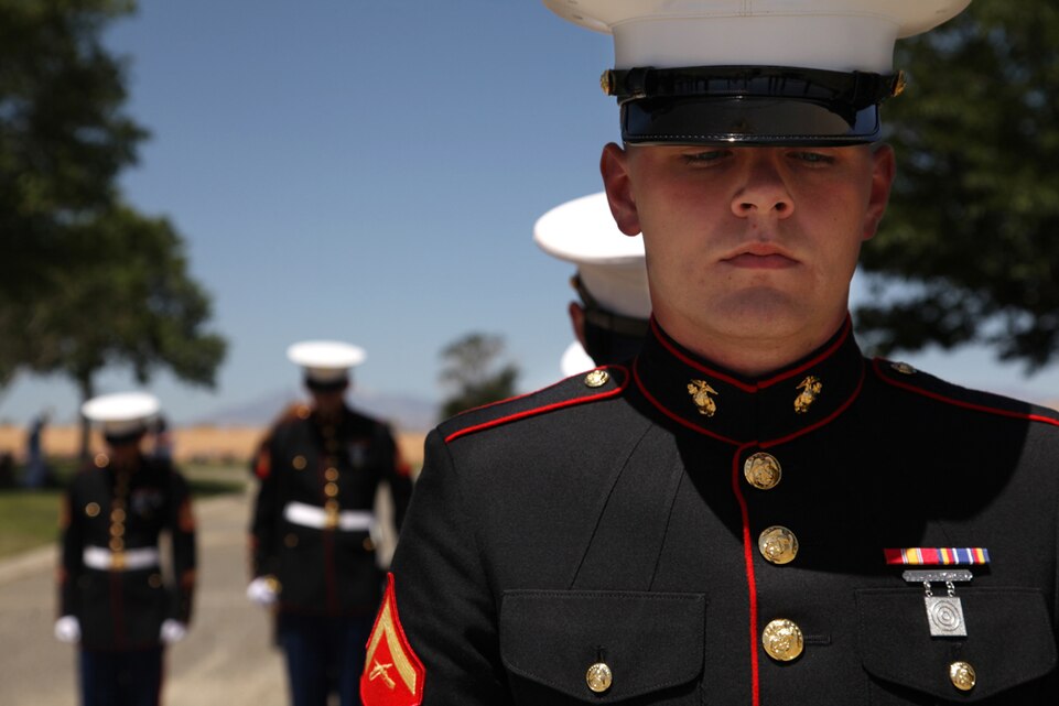 Lance Cpl. Craig Mikolas, Combat Center Honor Guard, bows his head during a prayer at a Memorial Day ceremony at Joshua Tree Memorial Park and Mortuary, May 27.
