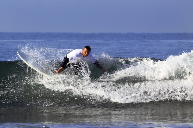 Col. Paul Miller with Headquarters and Support Battalion, Marine Corps Installations West, rides the very first set of waves during the 6th annual 2013 USAA Commanding General's Surf Competition at the San Onofre Beach here, June 11. More than 40 active duty Marines and sailors participated in the competition.