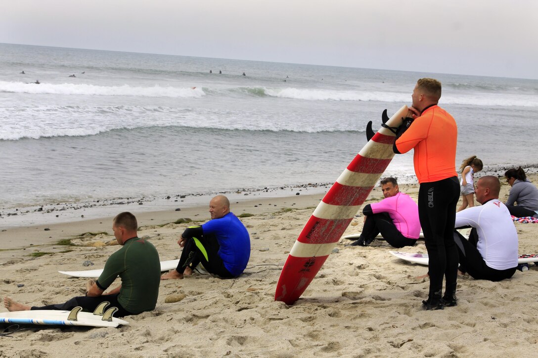 Competitors of the 6th annual 2013 USAA Commanding General's Surf Competition sit and wait to take their position in the waves of the San Onofre Beach here, June 11. The winners of the CG's surf competition were given automatic entry into the Red Bull Rivals competitions held July 13.