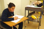 Louisiana National Guard Job Challenge Program cadet, 17-year-old Madie C. Denning of Houma, La., takes her final exam, which includes ambulance operations, gaining access and rescue operations, special operations and EMS response to terrorism, to become a certified emergency medical technician. JCP, which is located at the Gillis W. Long Center in Carville, La., helps at-risk youth get back on track while receiving valuable job-skill training. Emergency medical technician is one of eight trade certifications JCP has to offer.