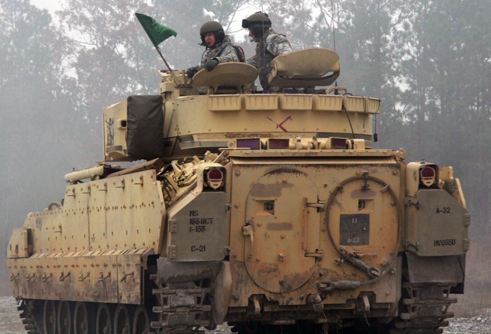 Army Capt. Michael Riley, commander of Company C, 1-185th Combined Arms Battalion, and Army Brig. Gen. Keith Jones, assistant deputy adjutant general for California's Army National Guard, get front-row action as they observe a M2 Bradley fighting vehicle live-fire exercise at Camp Shelby, Miss. The exercise is part of training to ready the 1-185th CAB for a deployment to Kosovo.