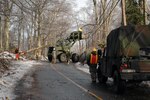 Guardsmen from the 379th Engineer Company of the Massachusetts Army National Guard, use a front end loader to get a better look at a damaged utility pole in Phillipston, Mass., on Dec. 14, 2008. The 379th was mobilized when Gov. Deval L. Patrick declared a state of emergency on Dec., 12, 2008.