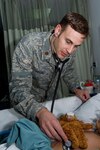 Maj. (Dr.) Christopher Kieling listens to an Iraqi child's heart in the Air Force Theater Hospital's intensive care unit at Joint Base Balad, Iraq, Dec. 11. Kieling, a native of Anchorage, Alaska, is deployed from the Uniformed Services University of Health Services at Bethesda, Md.