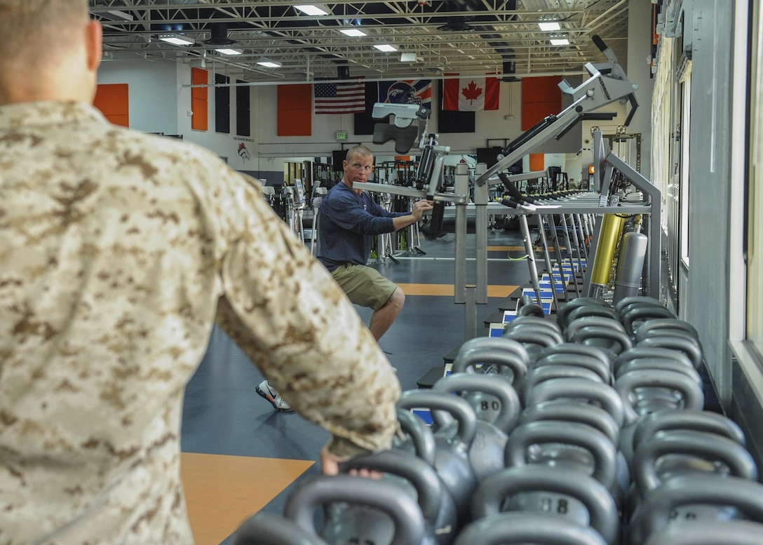 Anthony Lomando, Denver Broncos assistant strength and conditioning coach, talks overall fitness with Marines from Company B, Intelligence Support Battalion June 7, 2013 at the Denver Broncos training facility in Englewood, Colo. The 12 Marines in attendance tried out some of the equipment in the facility and were given tips they plan on incorporating into their daily physical training sessions.