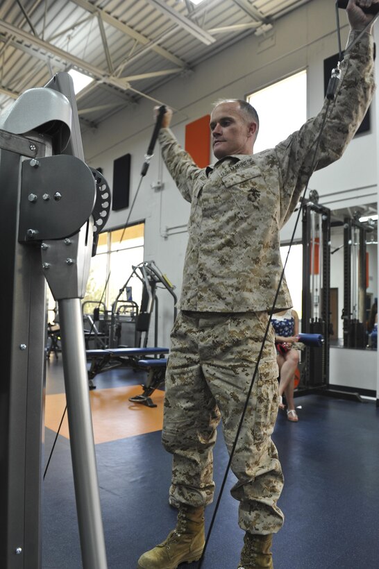 Maj. Brendan Egan, executive officer with Company B, Intelligence Support Battalion,Force Headquarters Group, exercises on a pneumatic weight machine during a tour June 7, 2013, at the Denver Broncos training facility in Englewood, Colo. During the tour, the 12 Buckley Air Force Base, Colo. Marines tested the state-of-the-art exercise equipment used by the Broncos. They were given tips to improve overall health, physical fitness and exercise techniques.