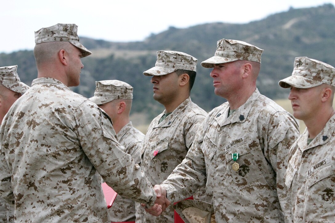 Gunnery Sgt. Benjamin W. Stryffeler, platoon sergeant serving with 1st Battalion, 1st Marine Regiment, is presented the Navy and Marine Corps Commendation Medal with combat "V" for valor here, June 11, 2013. Stryffeler was awarded for his heroic achievements while serving as a platoon sergeant during the battalion's deployment to Afghanistan in 2012. During the deployment, Stryffeler led his Marines during several fierce small-arms engagements, exposed himself to hostile fire to ensure the safety of his Marines and conducted four casualty evacuations for Marines and Afghans, helping to provide lifesaving aid to his wounded.