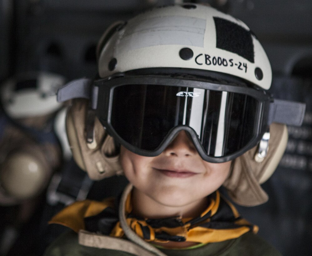 A child wears a cranial during Junior Jarhead Day hosted by Marine Aircraft Group 16 aboard Marine Corps Air Station Miramar, Calif., June 8. Crew chiefs took the children into an MV-22B Osprey and taught them about their job with the power of imagination.