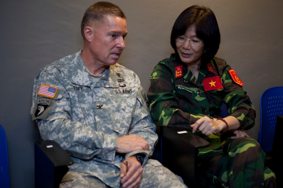 Vietnam People's Army Sr. Col. Do Mai Khanh (right), lead medical officer, and U.S. Army Col. Steven Toft, senior U.S. medical representative, attend a multinational presentation of the Association of Southeast Nations Defence Ministers Meeting-Plus ASEAN Humanitarian Assistance/Disaster Relief and Military Medicine Exercise hosted by Brunei Darussalam June 10 at the Multinational Coordination Centre in Muara, Brunei. The ASEAN exercise marks the first time multinational forces will conduct a field training exercise under the ADMM-Plus architecture and is a milestone event for regional cooperation. More than 1,800 multinational personnel from 18 Asia-Pacific nations are participating in the ASEAN exercise from June 16 to 20.