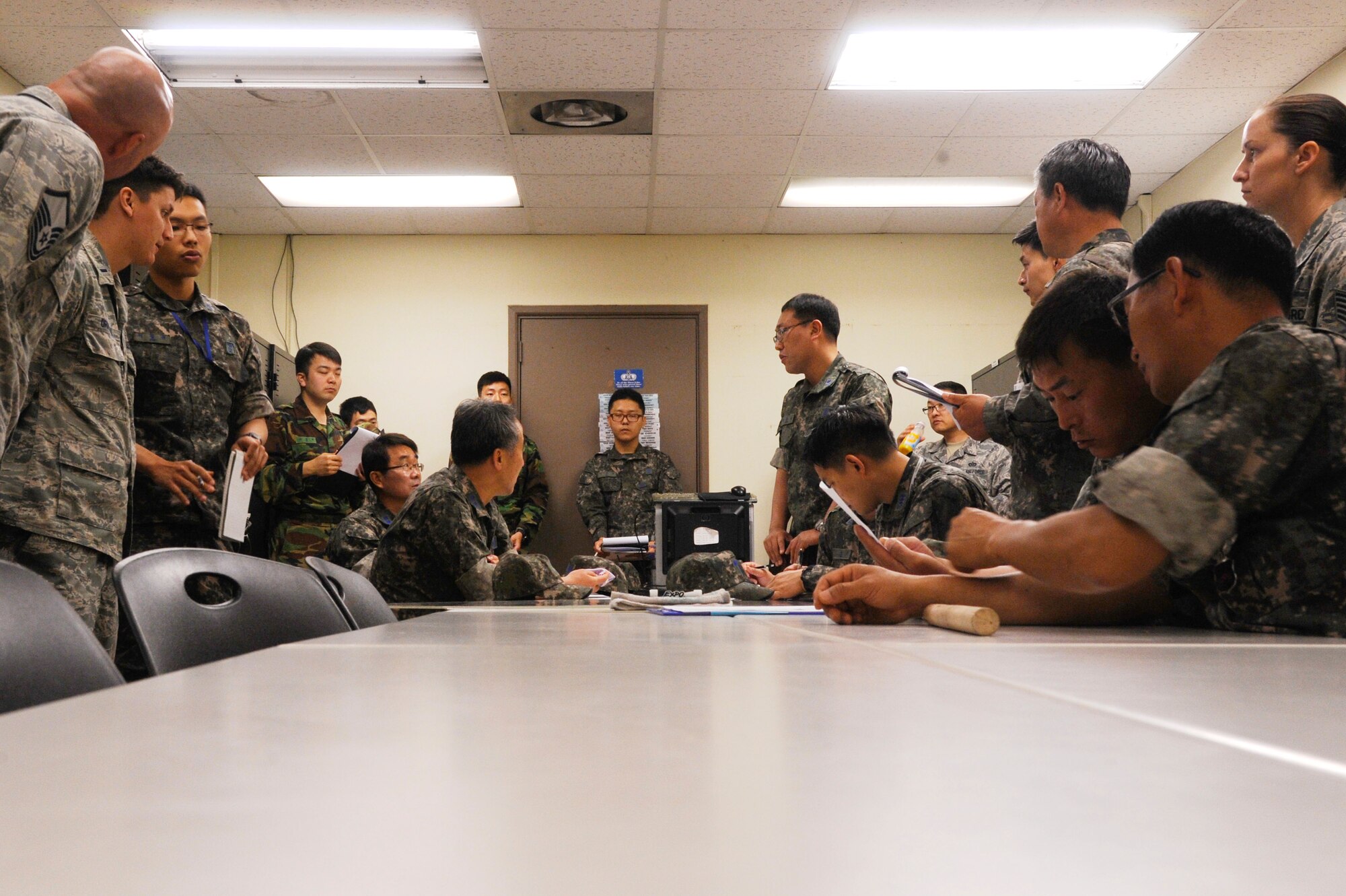 KUNSAN AIR BASE, Republic of Korea – United States and Republic of Korea air forces meet to discuss the joint response plan for the scheduled chemical, biological, radiological and nuclear attack exercise at Kunsan Air Base, ROK, June 5, 2013. Unlike other base exercises, this one was unique in that it specifically focused on CBRN units and their capabilities during an emergency response. (U.S. Air Force photo by Senior Airman Jessica Haas/ Released)