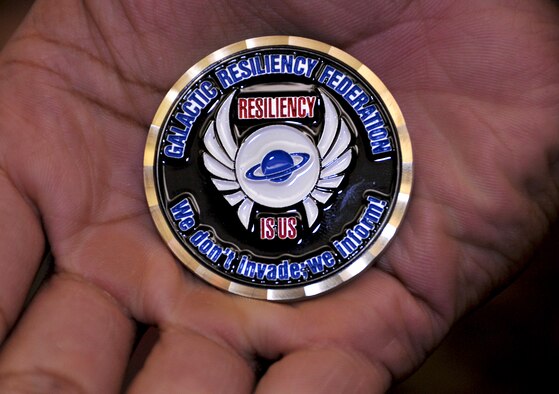 Airman 1st Class  Taali Ruffin, 51st Security Forces tactical automated security system administrator, recieves a coin after filling out an event feedback form at the REBOUND Resiliency Seminar at Yongsan Army Garrison, Republic of Korea, June 8, 2013. Other perks included a two-night stay at the Dragon Hill Lodge, free meals and snacks during the day, a free t-shirt, alien plush dolls and a chance to win prizes. (U.S. Air Force photo/Senior Airman Kristina Overton)