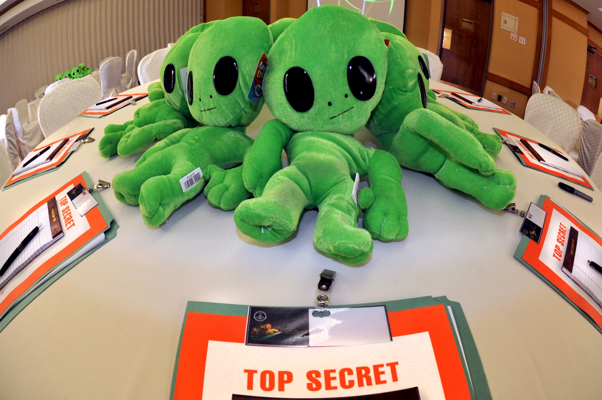 Alien plush dolls sit on each table along with top secret files during the REBOUND Resiliency Seminar at Yongsan Army Garrison, Republic of Korea, June 8, 2013. The files were filled with worksheets breaking down the acronym REBOUND, which stands for: reframing; empathy and encouragement; build support relationships; open and clear communication; undo negative scripts and navigate reality into successes and failures; and develop holistic health. (U.S. Air Force photo/Senior Airman Kristina Overton)