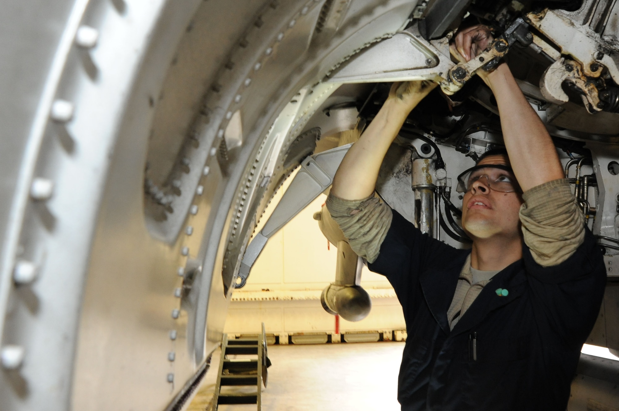 U.S. Air Force Senior Airman Jacob Gonzalez, 35th Aircraft Maintenance Squadron, works on the main landing gear door of a U.S. Air Force F-16 Fighting Falcon during an Operational Readiness Exercise at Misawa Air Base, Japan, June 12, 2013. Gonzalez, a 5-year Air Force veteran, said he takes pride in playing a behind-the-scenes role of the 35th Fighter Wing mission, which is the suppression of enemy air defenses. (U.S. Air Force photo by Senior Airman Derek VanHorn)