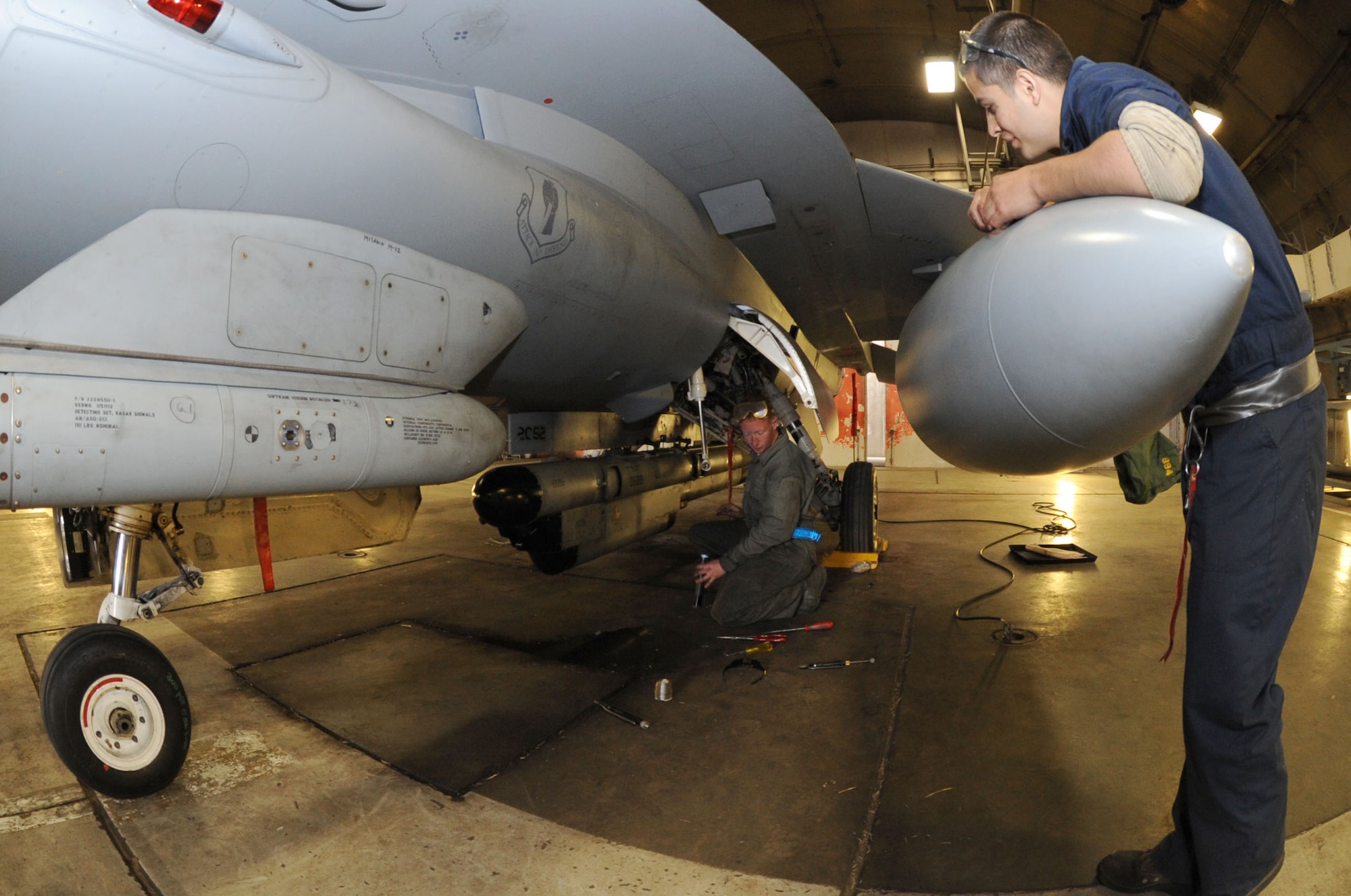 U.S. Air Force Senior Airman Jacob Gonzalez, right, 35th Aircraft Maintenance Squadron, asks a question of fellow squadron maintainer, Staff Sgt. Michael Schaefer, at Misawa Air Base, Japan, June 12, 2013. Maintainers from the 35 AMXS generated U.S. Air Force F-16 Fighting Falcons as part of a week-long Operational Readiness Exercise. (U.S. Air Force photo by Senior Airman Derek VanHorn)