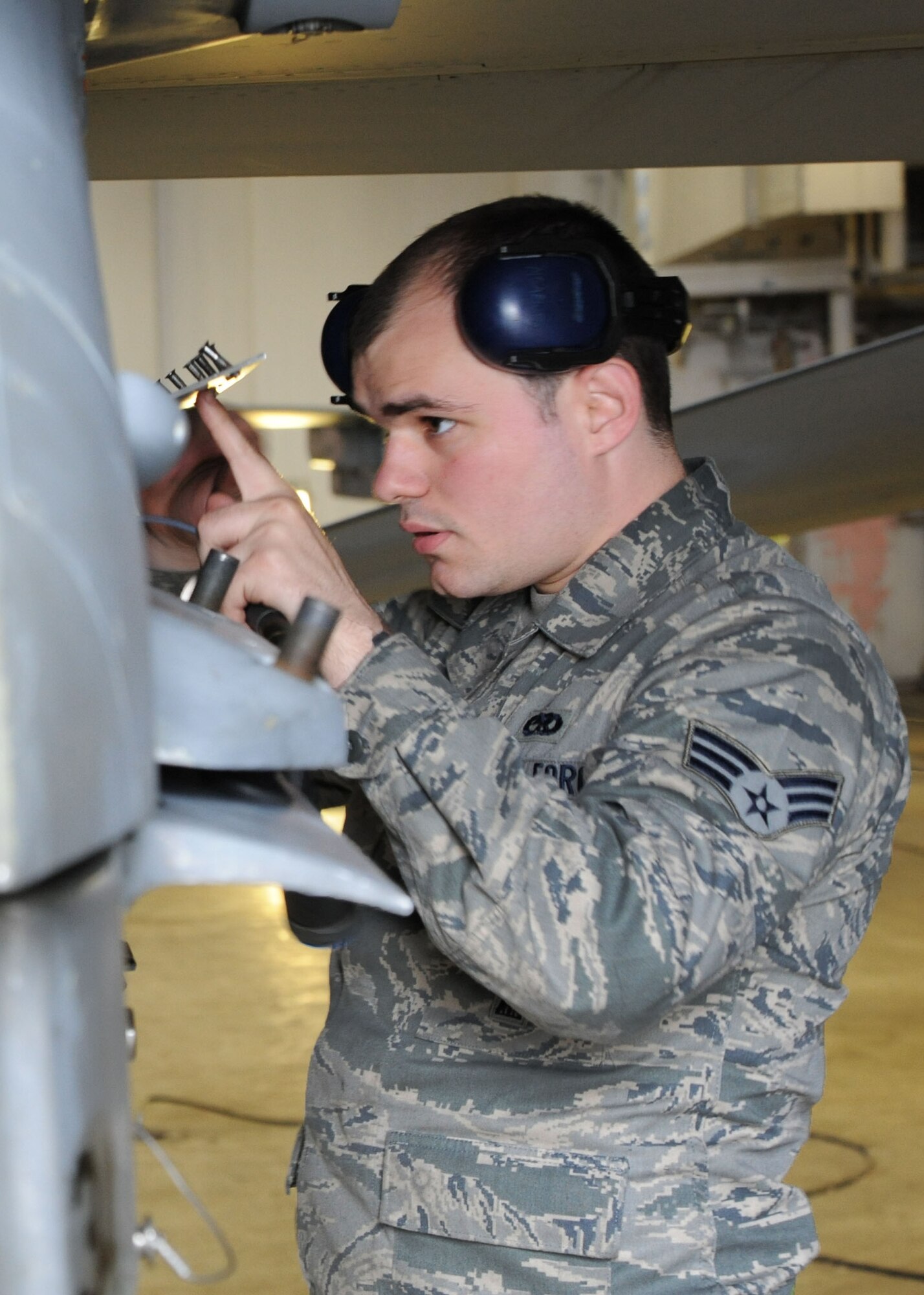 U.S. Air Force Senior Airman Charles Sappington, 35th Aircraft Maintenance Squadron, secures a panel on an F-16 Fighting Falcon at Misawa Air Base, Japan, June 12, 2013. Sappington teamed up with fellow 35 AMXS maintainers to generate mission capable F-16s for an Operational Readiness Exercise. (U.S. Air Force photo by Senior Airman Derek VanHorn)