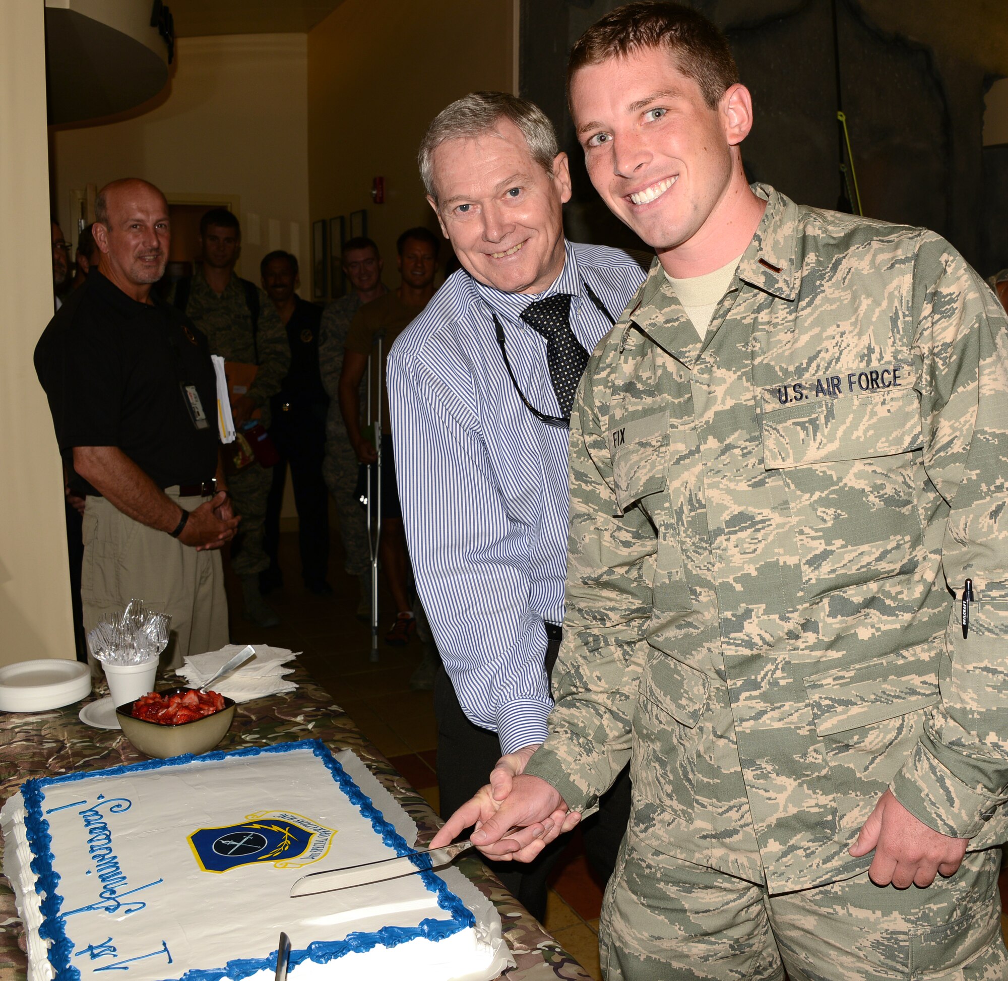 The youngest Airman at the Special Tactics Training Squadron, student trainee Second Lt. Brandon Fix, and the oldest member of the 24th Special Operations Wing, retired Chief Master Sgt. Wayne Norrad cut a cake June 12, 2013 marking the first birthday of the 24 SOW. The 24 SOW is the first USAF wing devoted to special tactics and is the most highly decorated wing since Vietnam. (Photo by Rachel Arroyo/Released) 
