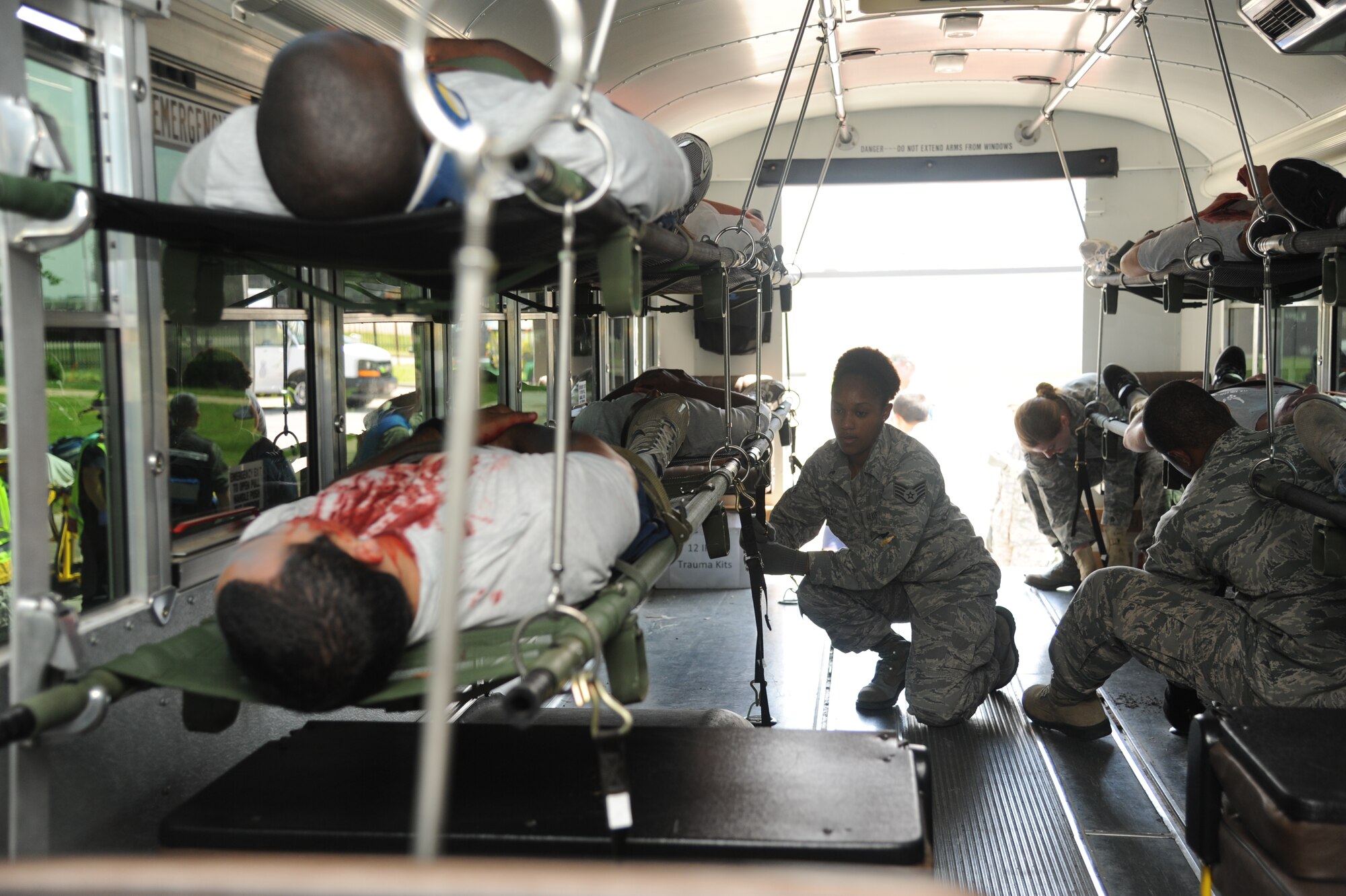 Staff Sgt. René Roddy, 81st Dental Squadron, secures patients on an ambulance for transport to the Keesler Medical Center during Keesler's active shooter exercise, June 12, 2013, at Garrard Hall, Keesler Air Force Base, Miss.  During the two-day exercise, an Air Force couple simulated opening fire, killing three people and injuring 41.  The exercise tested the base's ability to respond to and recover from a mass casualty event.  (U.S. Air Force photo by Kemberly Groue)