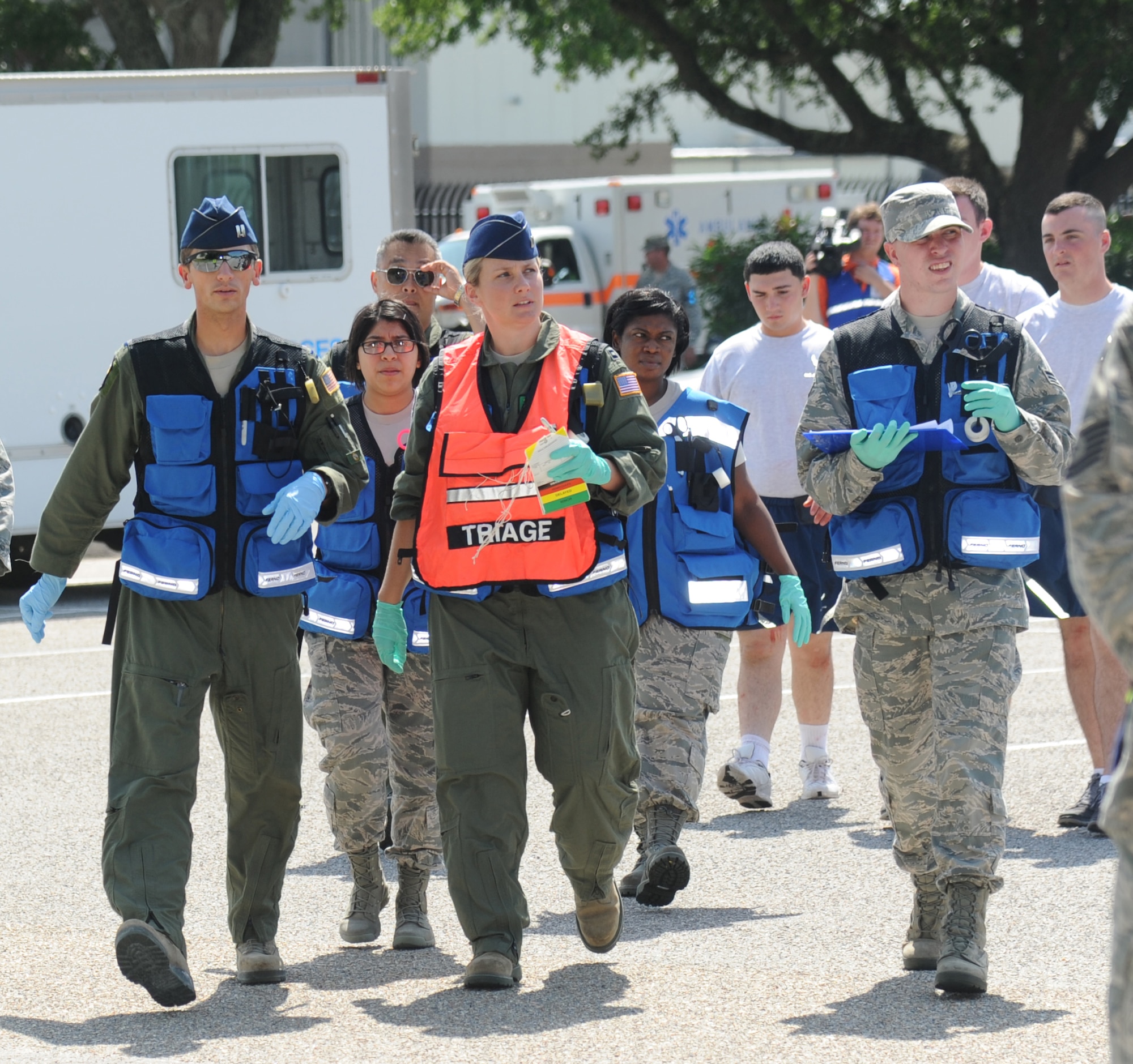 Members of the 81st Medical Group arrive on-scene to assess the situation, administer simulated triage and transport wounded “victims” to the Keesler Medical Center during Keesler's active shooter exercise, June 12, 2013, at Garrard Hall, Keesler Air Force Base, Miss.  During the two-day exercise, an Air Force couple simulated opening fire, killing three people and injuring 41.  The exercise tested the base's ability to respond to and recover from a mass casualty event.  (U.S. Air Force photo by Kemberly Groue)