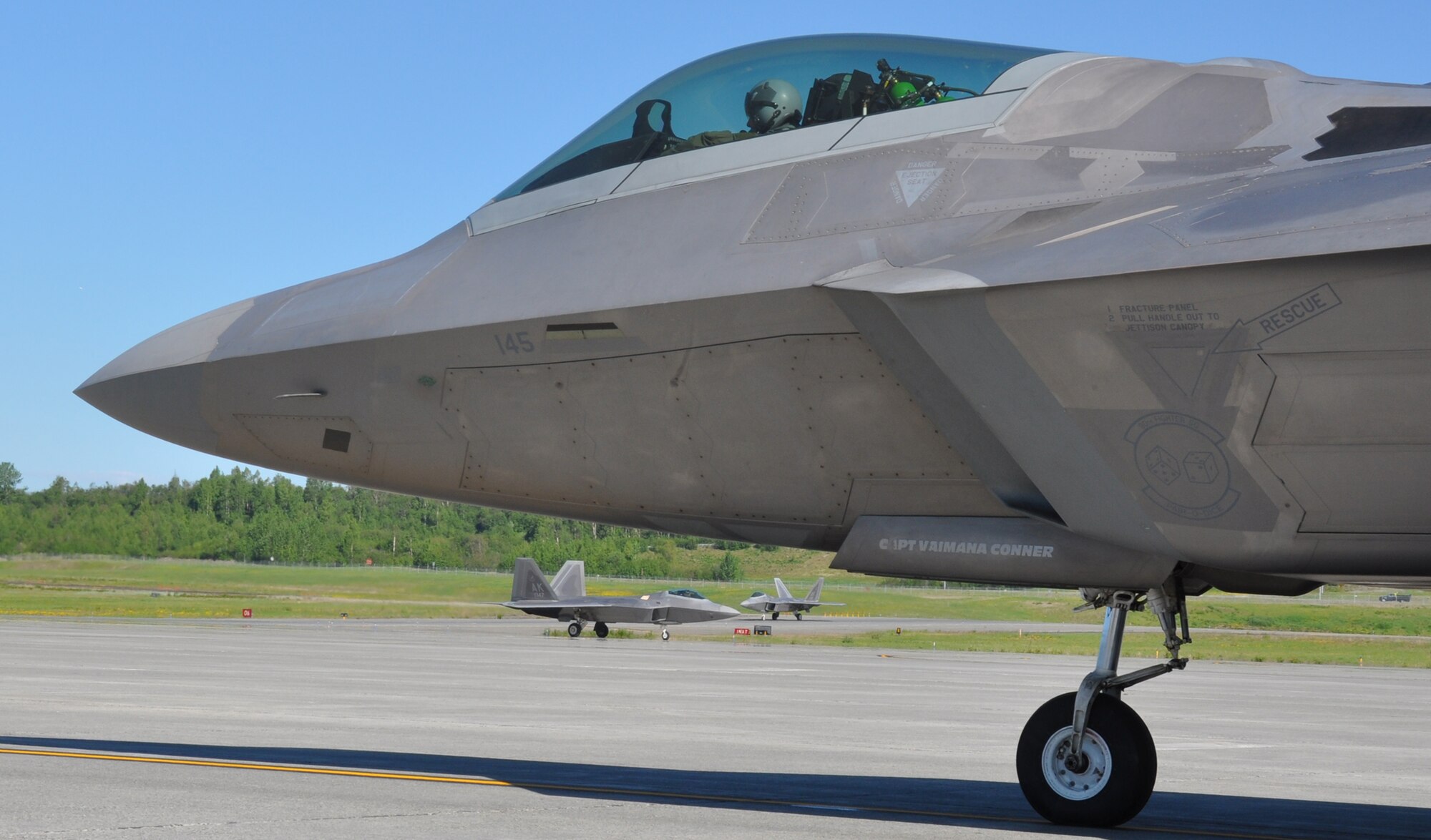 F-22’s assigned to the 3rd Wing taxi into the hot pits after flying a sortie here June 12.  F-22 pilots from the 90th, 525th and 302nd Fighter Squadrons flew over 90 sorties June 11-12 to test the maintenance and flying capability of Alaska’s Raptors. (U.S. Air Force/Capt. Ashley Conner) 

