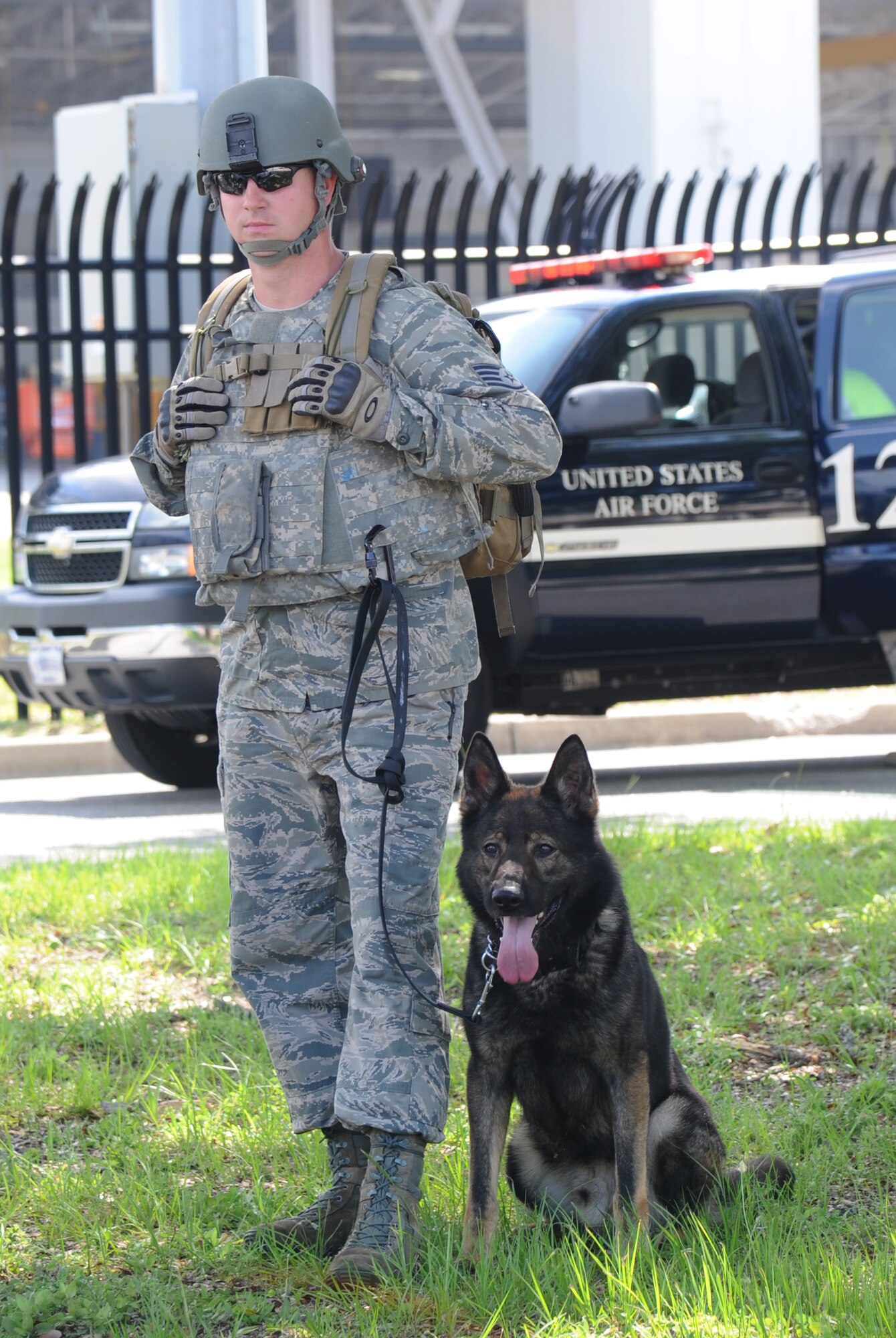 Staff Sgt. Javonnia Peak, 81st Security Forces Squadron, and military working dog, Bady, stand guard during Keesler's active shooter exercise, June 12, 2013, at Garrard Hall, Keesler Air Force Base, Miss.  During the two-day exercise, an Air Force couple simulated opening fire, killing three people and injuring 41.  The exercise tested the base's ability to respond to and recover from a mass casualty event.  (U.S. Air Force photo by Kemberly Groue)