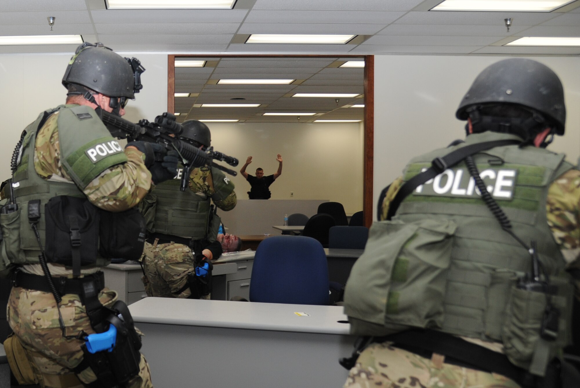 Biloxi Police Department's special response team members engage and apprehended a portrayed gunman ending his shooting spree during Keesler's active shooter exercise, June 12, 2013, at Garrard Hall, Keesler Air Force Base, Miss.  During the two-day exercise, an Air Force couple simulated opening fire, killing three people and injuring 41.  The exercise tested the base's ability to respond to and recover from a mass casualty event.  (U.S. Air Force photo by Kemberly Groue)