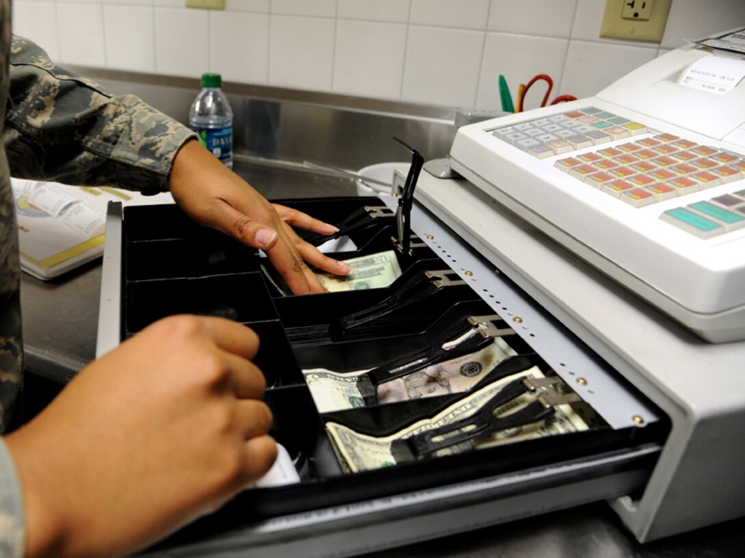 Airman 1st Class Lachaundre Wilson rings up a customer’s order and gathers their change from the cash register March 12, 2013, at a missile alert facility nearly two hours from Malmstrom Air Force Base, Mont. Missile chefs post out to the missile complex for four days during which they cook and serve meals, clean the kitchen, and check and update the food inventory, among other tasks. Wilson is a chef assigned to the 490th Missile Squadron. (U.S. Air Force photo/Staff Sgt. R.J. Biermann)