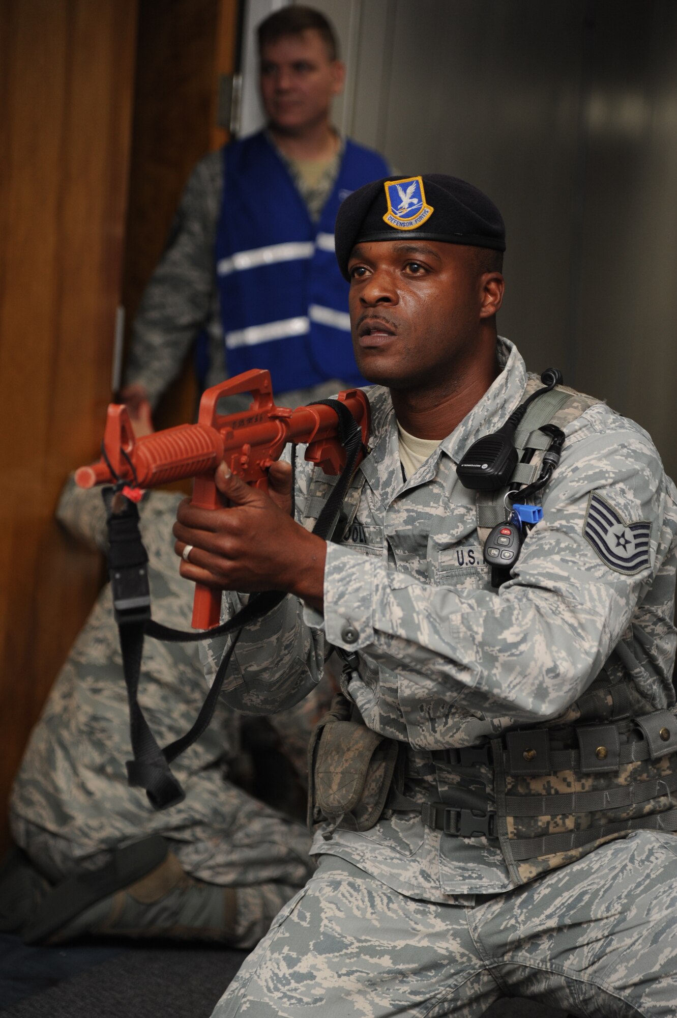 Tech. Sgt. Teddy Poole, 81st Security Forces Squadron, holds his position while approaching the room where a portrayed gunman held hostages during Keesler's active shooter exercise, June 12, 2013, at Garrard Hall, Keesler Air Force Base, Miss.During the two-day exercise, an Air Force couple simulated opening fire, killing three people and injuring 41.  The exercise tested the base's ability to respond to and recover from a mass casualty event.  (U.S. Air Force photo by Kemberly Groue)