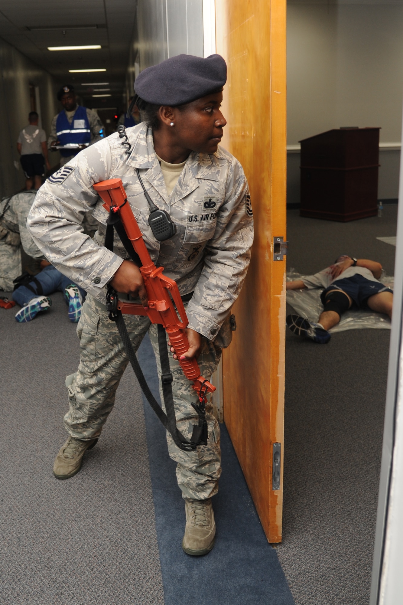 Tech. Sgt. Keishonda Signater, 81st Security Forces Squadron, sweeps the facility for the second portrayed gunman during Keesler's active shooter exercise, June 12, 2013, at Garrard Hall, Keesler Air Force Base, Miss. During the two-day exercise, an Air Force couple simulated opening fire, killing three people and injuring 41.  The exercise tested the base's ability to respond to and recover from a mass casualty event.  (U.S. Air Force photo by Kemberly Groue)