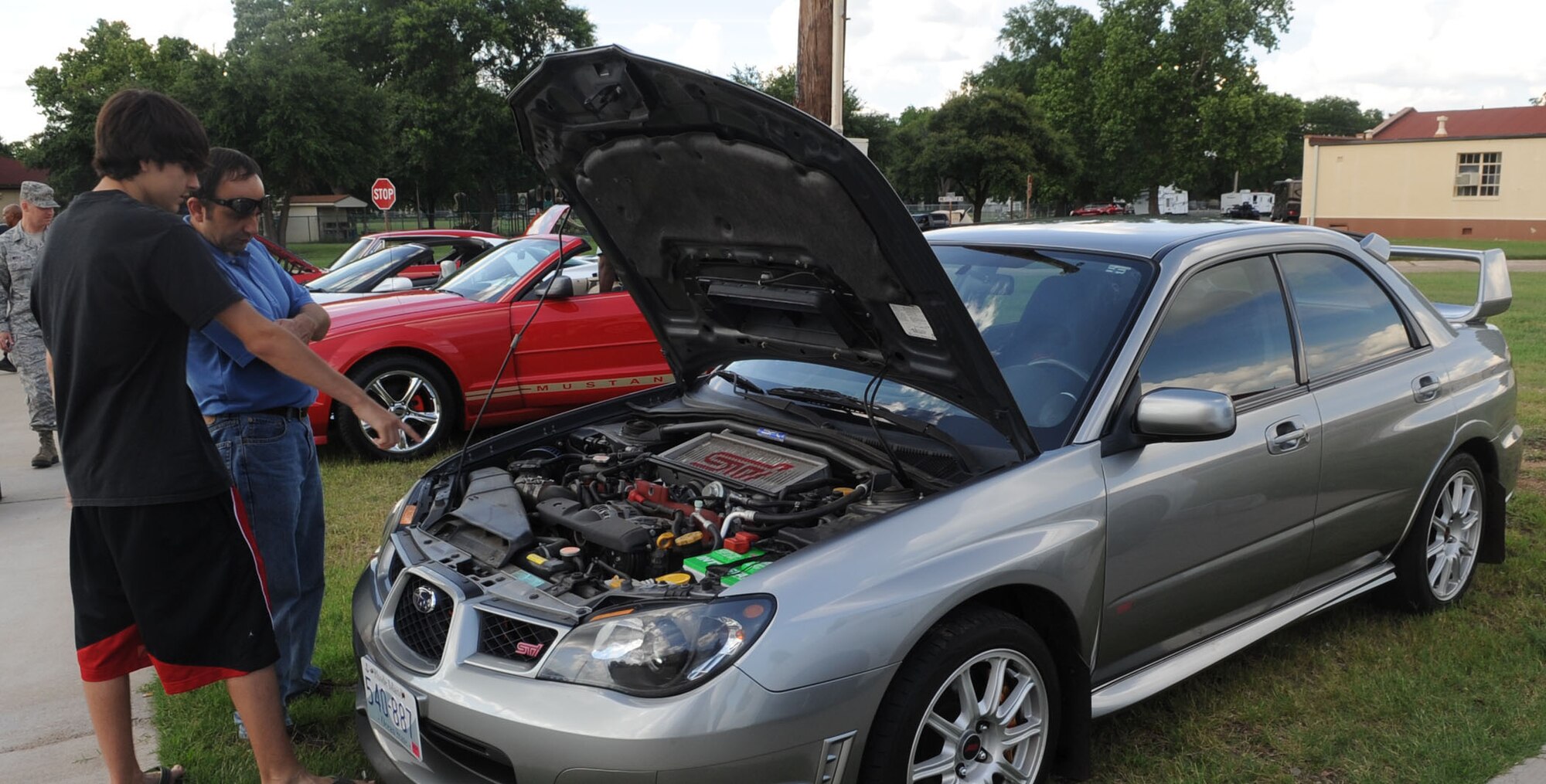 Ian Baca and retired Master Sgt. Al Baca admire a 2007 Subaru STI during the Auto Hobby Car & Bike Meet on Barksdale Air Force Base, La., June 7, 2013. The meet gave auto and motorcycle enthusiasts a chance to gather and show case their vehicles. (U.S. Air Force photo/Senior Airman Kristin High)