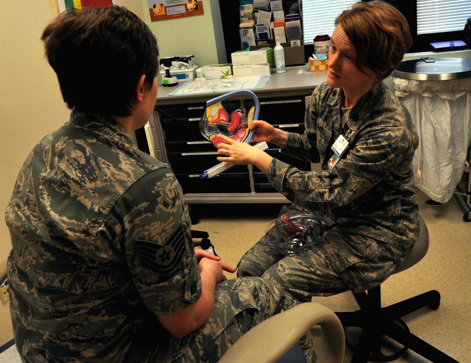 Maj. Stacy Slat, 375th Medical Group, OB/GYN physician shows Tech. Sgt. Anna Evans, 375th MDOS, flight chief of OB/GYN Services a model of the female reproductive organs. In recognition of Women’s Health Awareness Month, the Women’s Health Clinic will be hosting WELL women exams for those that are due for their annual exam June 24, 25 and 28. (U.S. Air Force photo/Airman Megan Friedl)