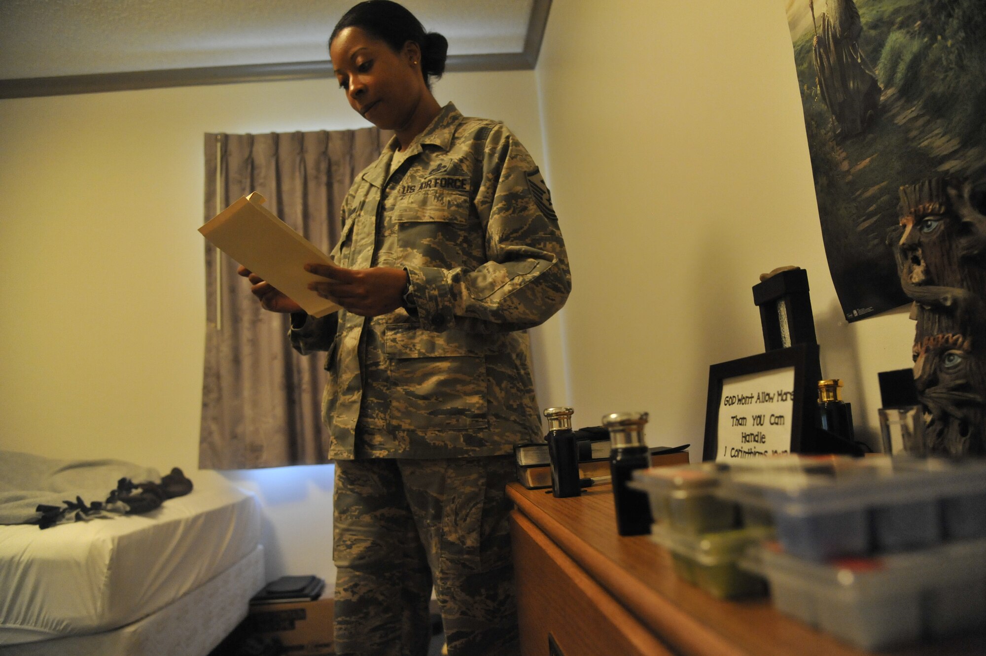 Master Sgt. Lafoundra Thompson, 509th Operations Group first sergeant, reviews an inspection checklist at Whiteman Air Force Base, Mo., June 3, 2013. The checklist is used to ensure each Airman meets specified guidelines during the room inspection. (U.S. Air Force photo by Airman 1st Class Keenan Berry/Released)