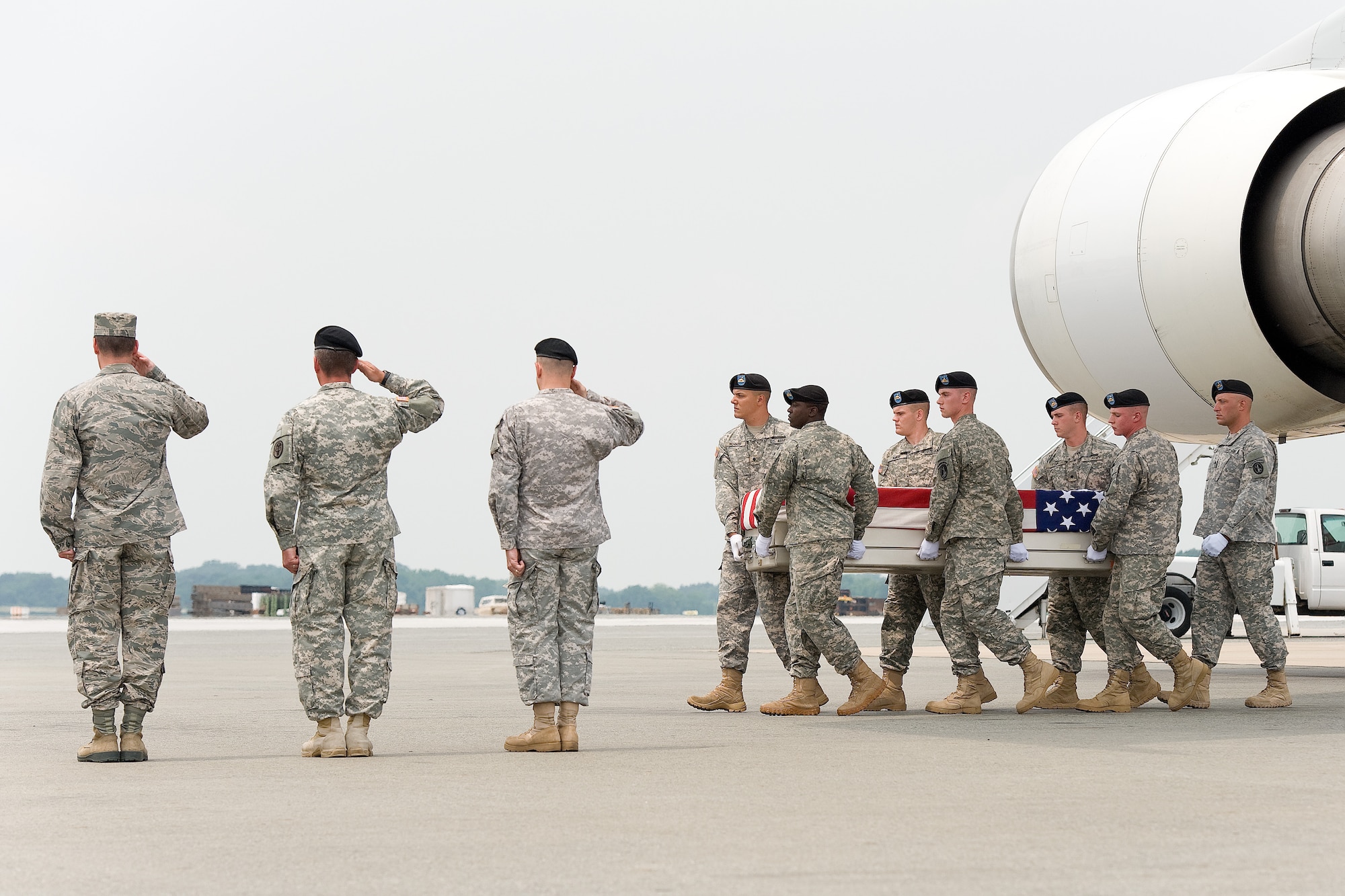 A U.S. Army carry team transfers the remains of Army Lt. Col. Todd J. Clark of Evans Mills, N.Y., at Dover Air Force Base, Del., on June 12, 2013. Clark was assigned to the Headquarters and Headquarters Company, 2nd Brigade Combat Team, 10th Mountain Division, Fort Drum, N.Y. (U.S. Air Force photo/Roland Balik)