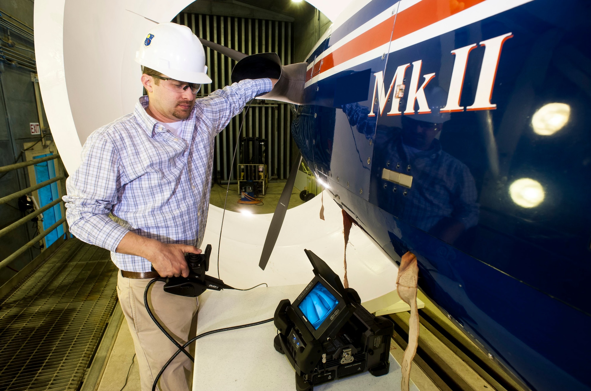 Before testing can begin at AEDC’s SL-1 test cell, Chris Rogers, an AEDC engineer, conducts a borescope inspection of the PT6 engine that powers the T-6 Texan II trainer aircraft. (Photo by Rick Goodfriend)