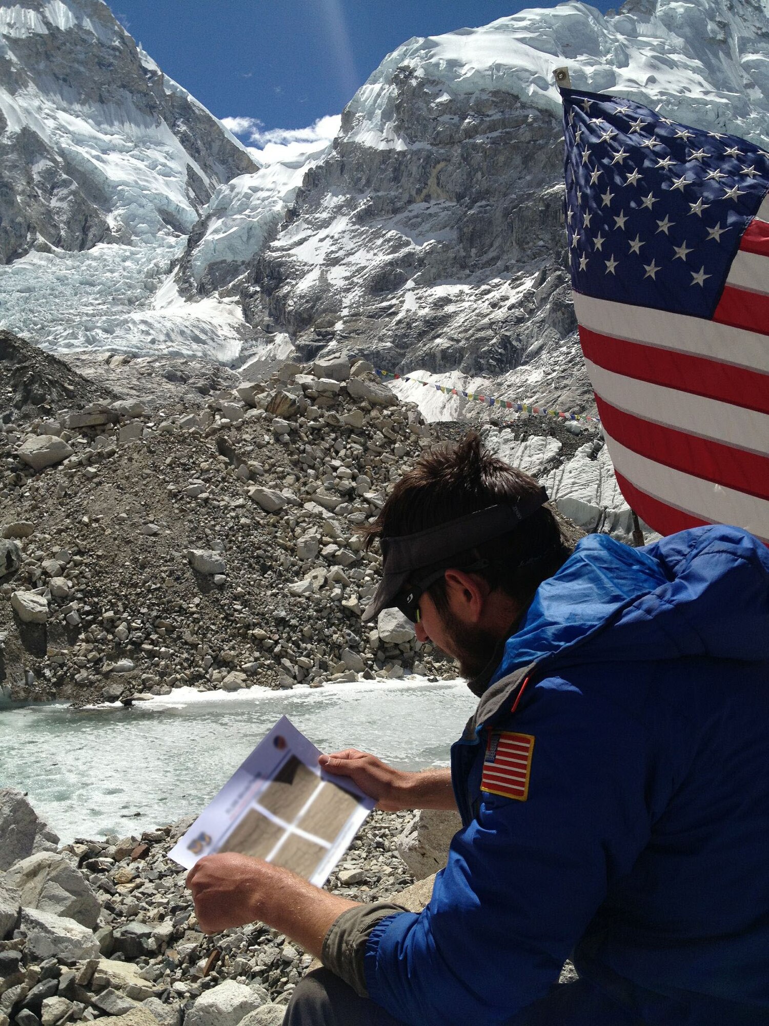 U.S. Air Force Capt. Kyle “Husky” Martin, a T-38 pilot and division chief for the 1st Operations Group, goes over weather plans for the U.S. Air Force 7 Summits team during their climb to reach Mount Everest. Airmen from Barksdale Air Force Base, La., and Hickam Air Force Base, Hawaii, supported the team with Himalayan mountain range weather forecasts.  (Courtesy photo by U.S. Air Force Capt. Colin Merrin/Released) (Parts of this photo blurred for security purposes)
