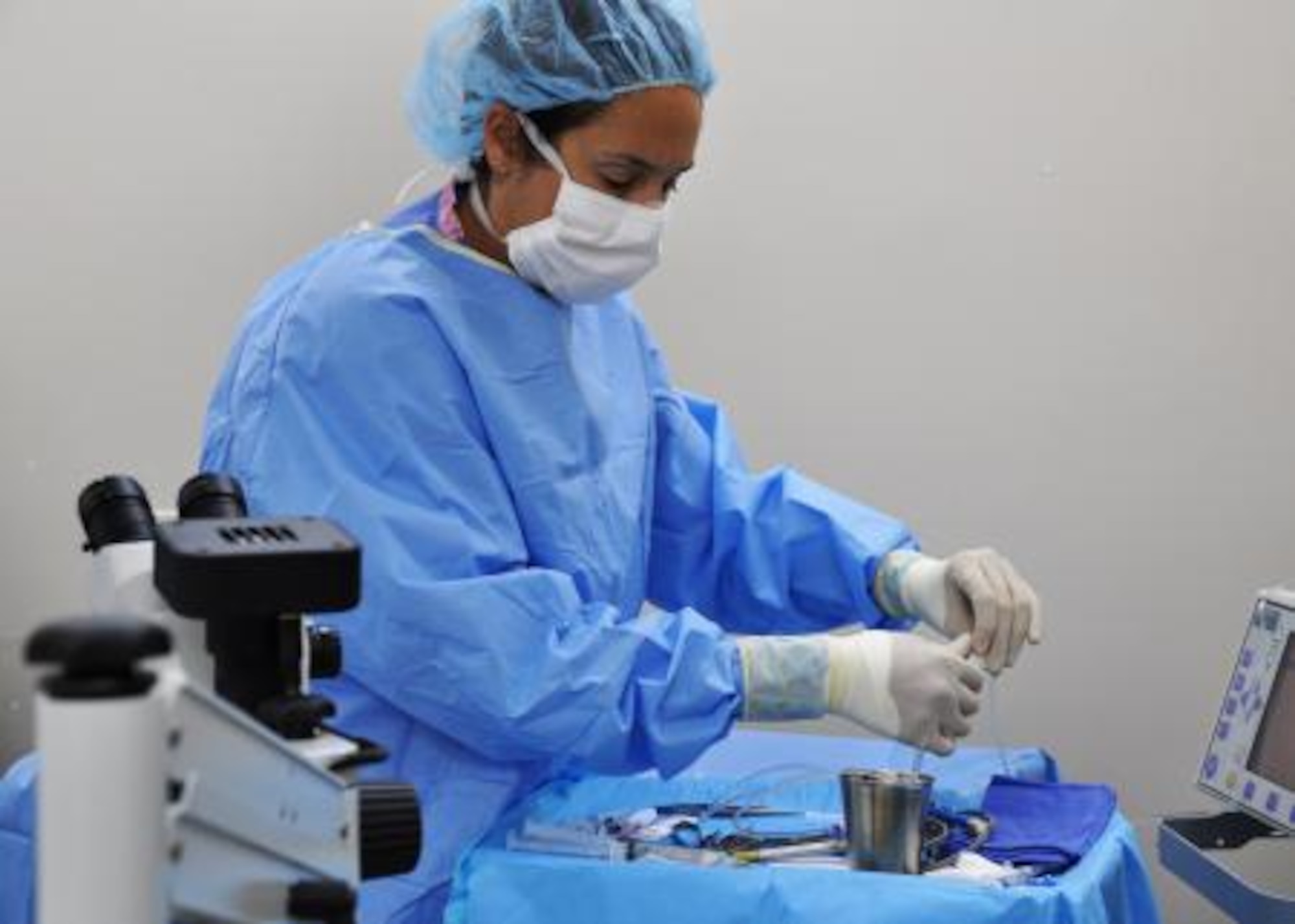 U.S. Air Force Master Sgt. Robin Pugh, ophthalmologist technician and noncommissioned officer in charge from Eglin Air Force Base, Fla., prepares for a cataract surgery June 5, 2013, at the Southern Regional Hospital in Dangriga, Belize. Military medical professionals from the U.S. and Canada have provided free medical treatment throughout Belize as part of an exercise known as New Horizons. The medical readiness training exercises are designed to provide humanitarian assistance and medical care to people throughout Belize, while helping improve the skills of U.S. military medical forces. (U.S. Air Force photo by Capt. Holly Hess/Released)
