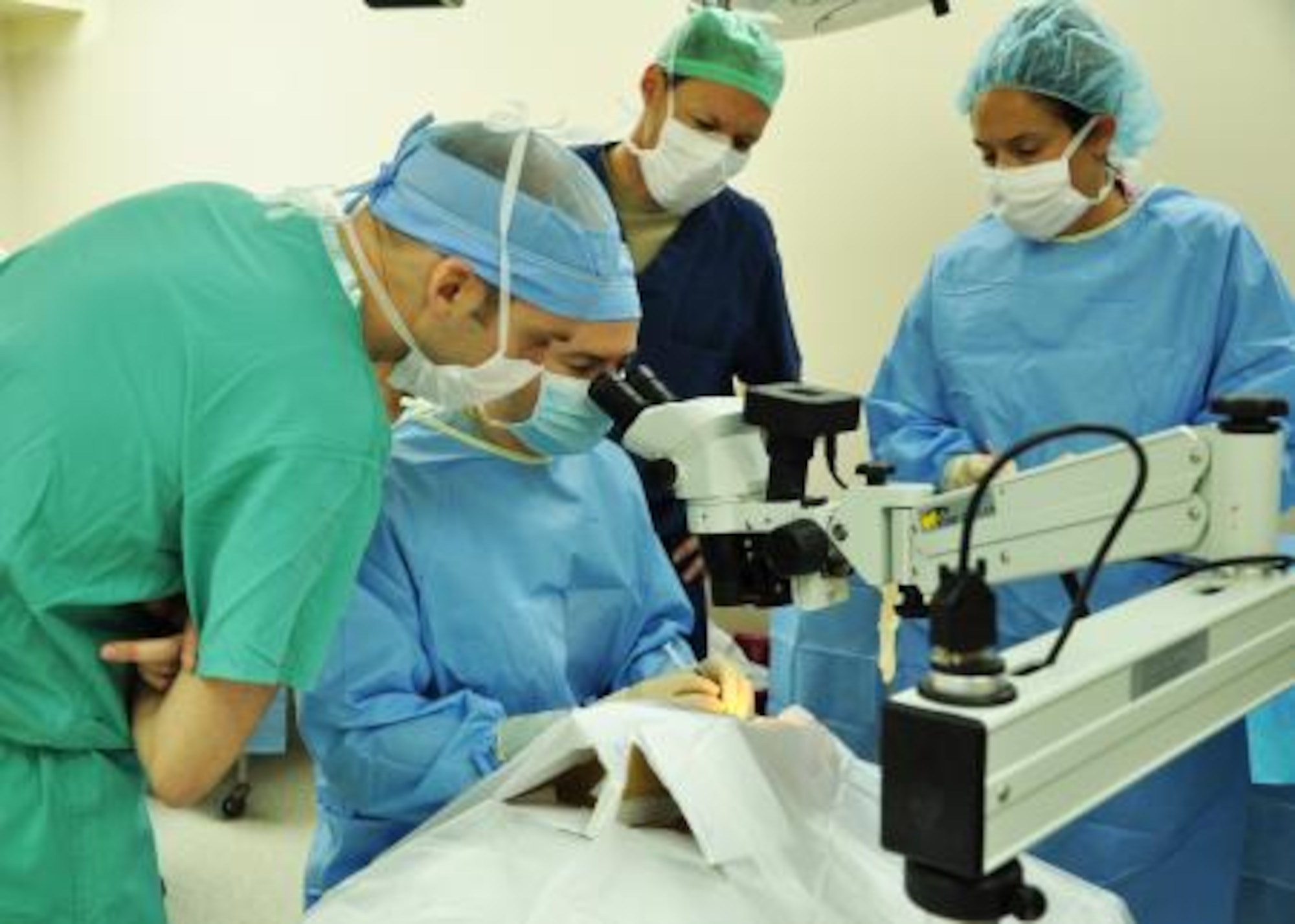 U.S. Air Force Maj. (Dr.) Richard Townley, seated, cornea and refractive surgeon from the 59th Medical Wing at Wilford Hall Ambulatory Surgical Center at Lackland Air Force Base, Texas, performs cataract surgery on a patient while other members of the ophthalmology medical readiness training exercise observe, June 5, 2013, at the Southern Regional Hospital in Dangriga, Belize. Military medical professionals from the U.S. and Canada have provided free medical treatment throughout Belize as part of an exercise known as New Horizons. The medical readiness training exercises are designed to provide humanitarian assistance and medical care to people throughout Belize, while helping improve the skills of U.S. military medical forces. (U.S. Air Force photo by Capt. Holly Hess/Released)