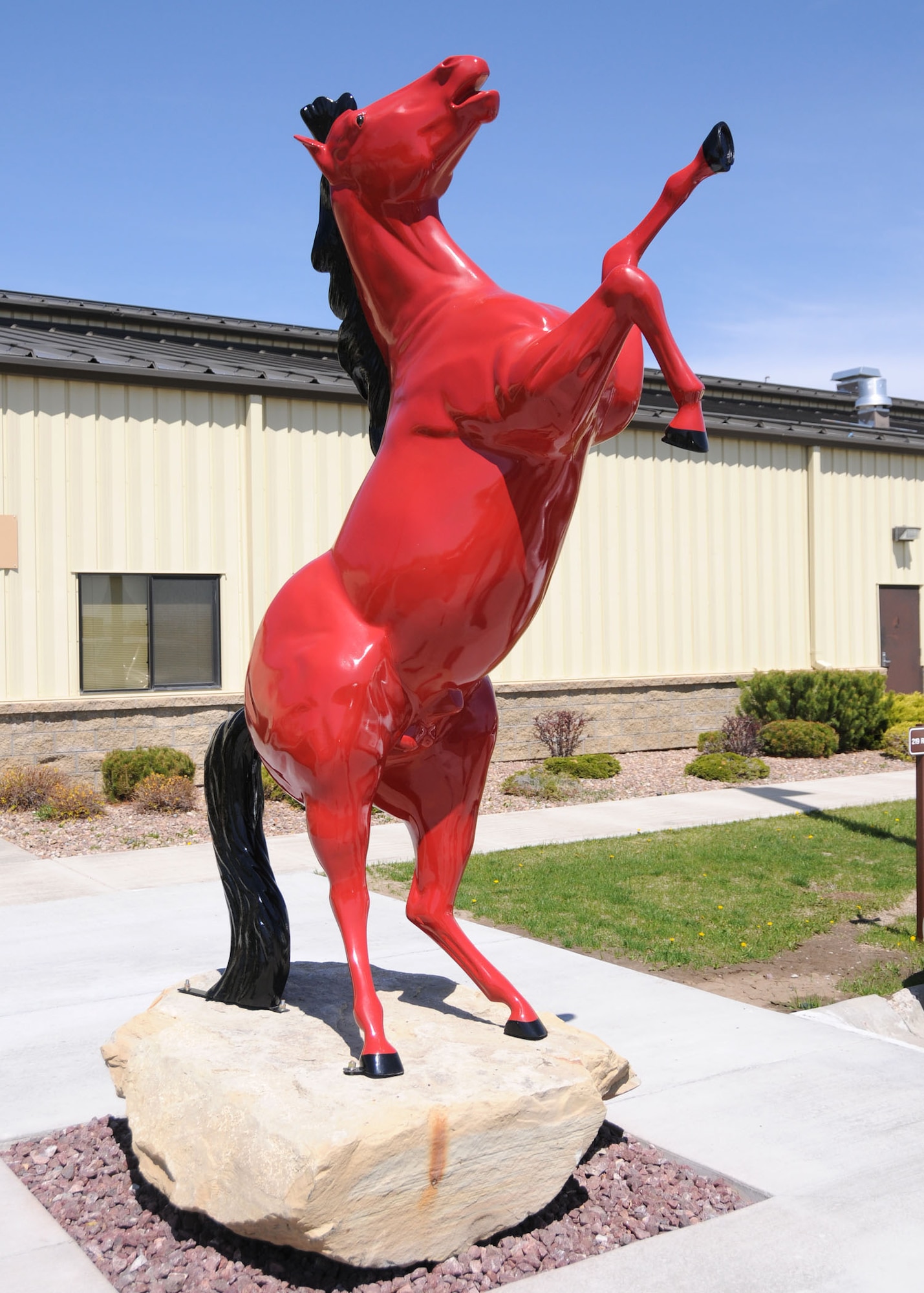 A Red Horse statue, symbolizing the 219th RED HORSE Squadron, and Malmstrom's 819th RED HORSE Squadron proudly stands outside of the administrative offices at Malmstrom Air Force Base. (U.S. Air Force photo/Senior Master Sgt. Eric Peterson)