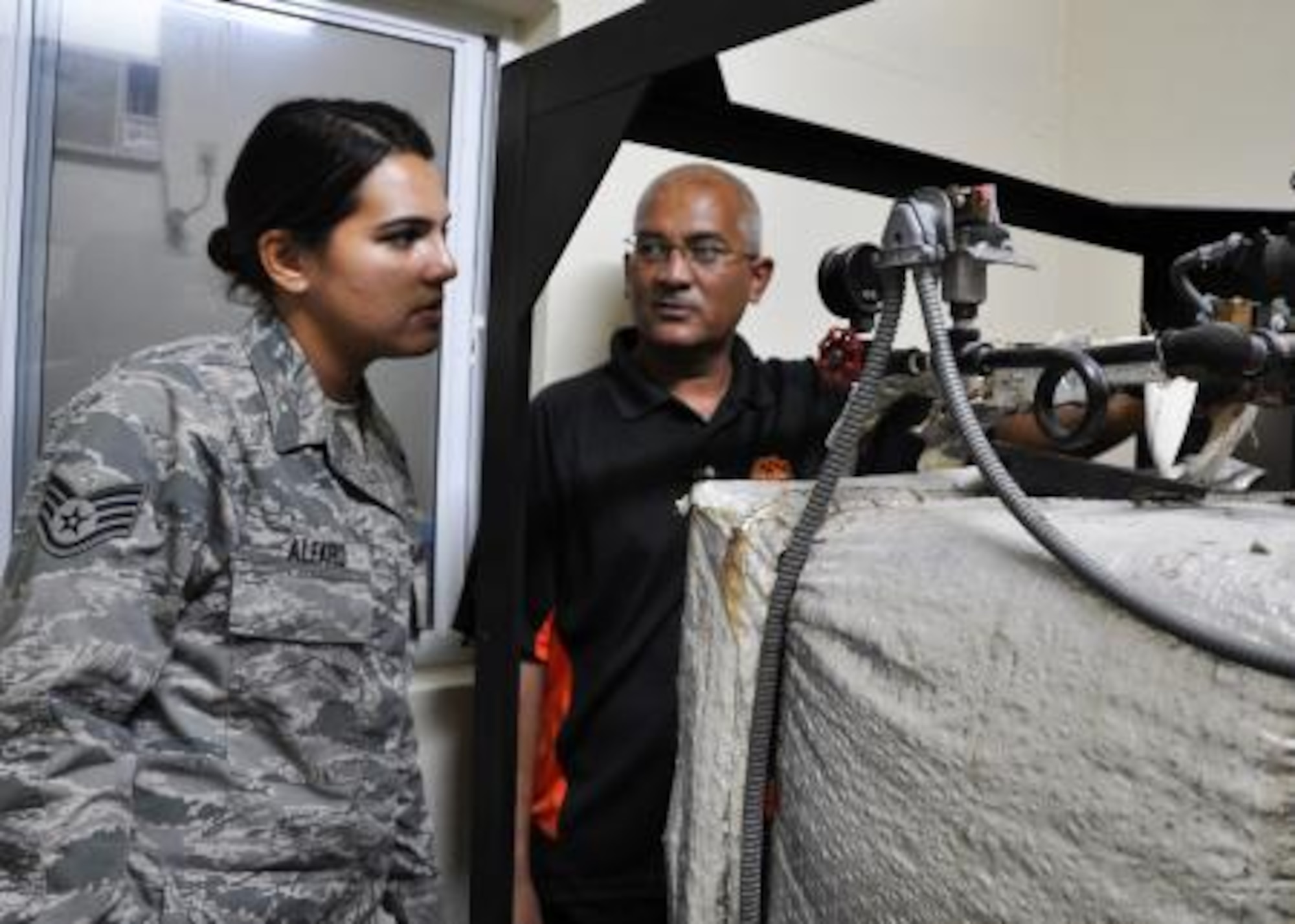 U.S. Air Force Staff Sgt. Rosalinda Alfaro, biomedical equipment technician from the 59th Medical Wing at Wilford Hall Ambulatory Surgical Center at Lackland Air Force Base, Texas, speaks with Roy Mencias, biomedical technician for the Northern Regional Hospital, regarding the hospital’s steam sterilizer June 6, in Orange Walk, Belize. Alfaro is repairing medical sterilizers with various problems throughout Belize in the towns of Belmopan, Orange Walk and Dangriga. The effort is part of a training exercise called New Horizons. The training is designed to provide humanitarian assistance and medical care to people throughout Belize, while helping improve the skills of U.S. military medical forces. (U.S. Air Force photo by Capt. Holly Hess/Released)
