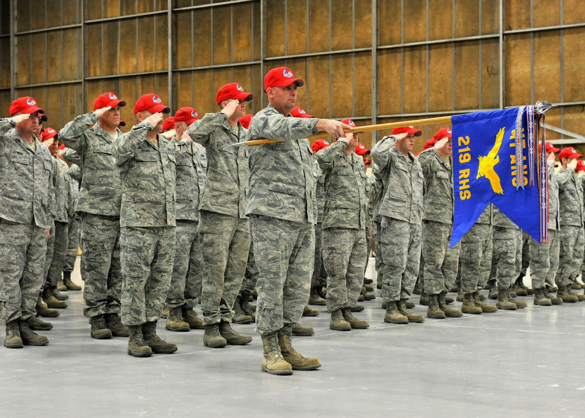 Members of the 219th RED HORSE Squadron salute during the posting of the colors during a change of command ceremony held at Malmstrom Air Force Base. (U.S. Air Force photo/Staff Sgt. John Turner)