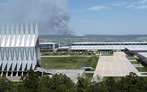 The Black Forest Fire smolders several miles east of the Air Force Academy in Colorado Springs, Colo., in this shot taken near the Cadet Chapel June 11, 2013. The fire burned between 7,500 and 8,000 acres the first day, as well as up to 100 homes. More than 5,000 people were evacuated from an additional 1,700 homes. (U.S. Air Force photo/Rich Droll)