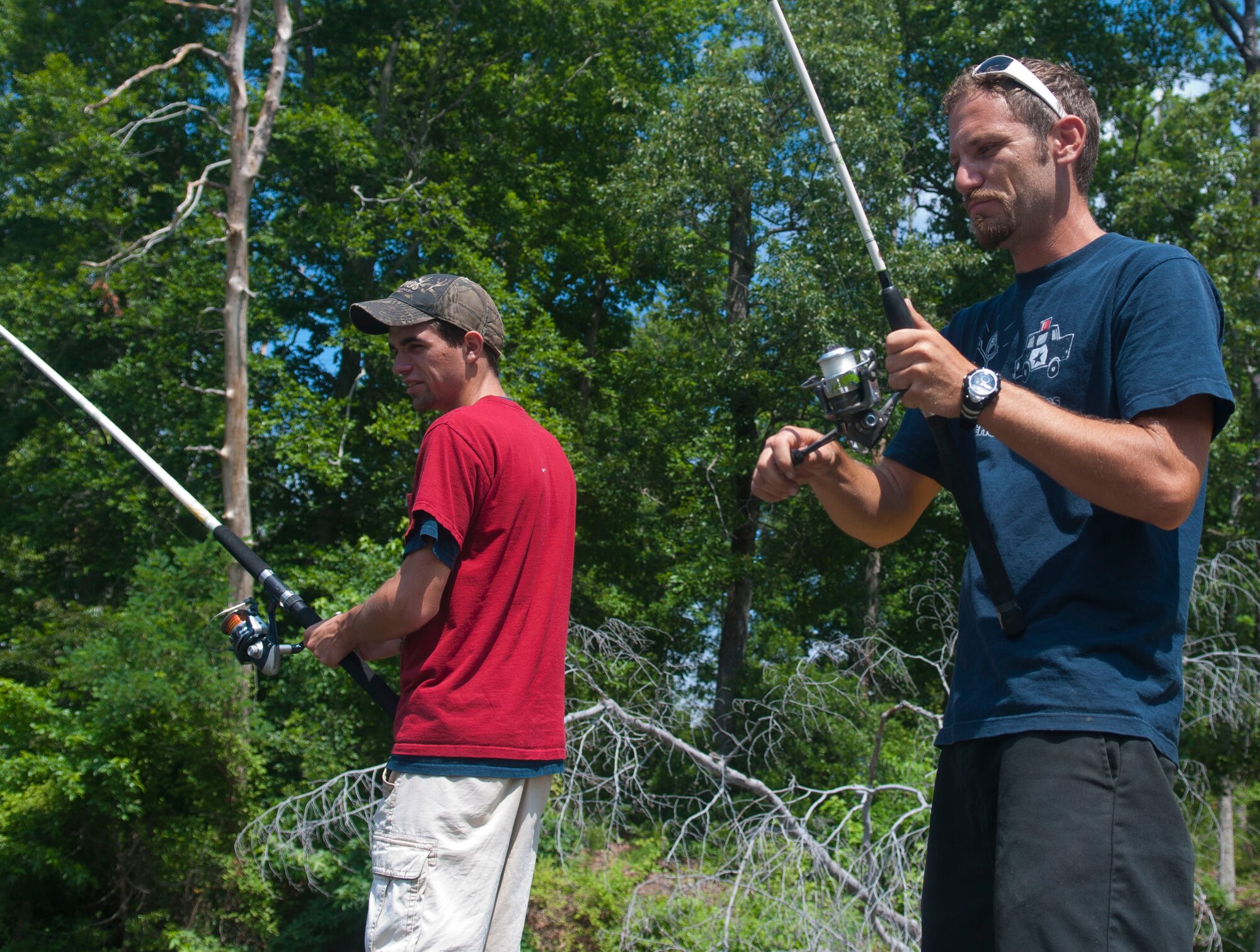 Sean Denton (left) and Ryan Stewart, both avid fishermen, cast their lines in Fort Eustis Lake, June 11, 2013 at Fort Eustis, Va. No license is required to fish in the lake, however aspiring anglers must release their catch. (U.S. Air Force photo by Airman 1st Class Austin Harvill/Released)