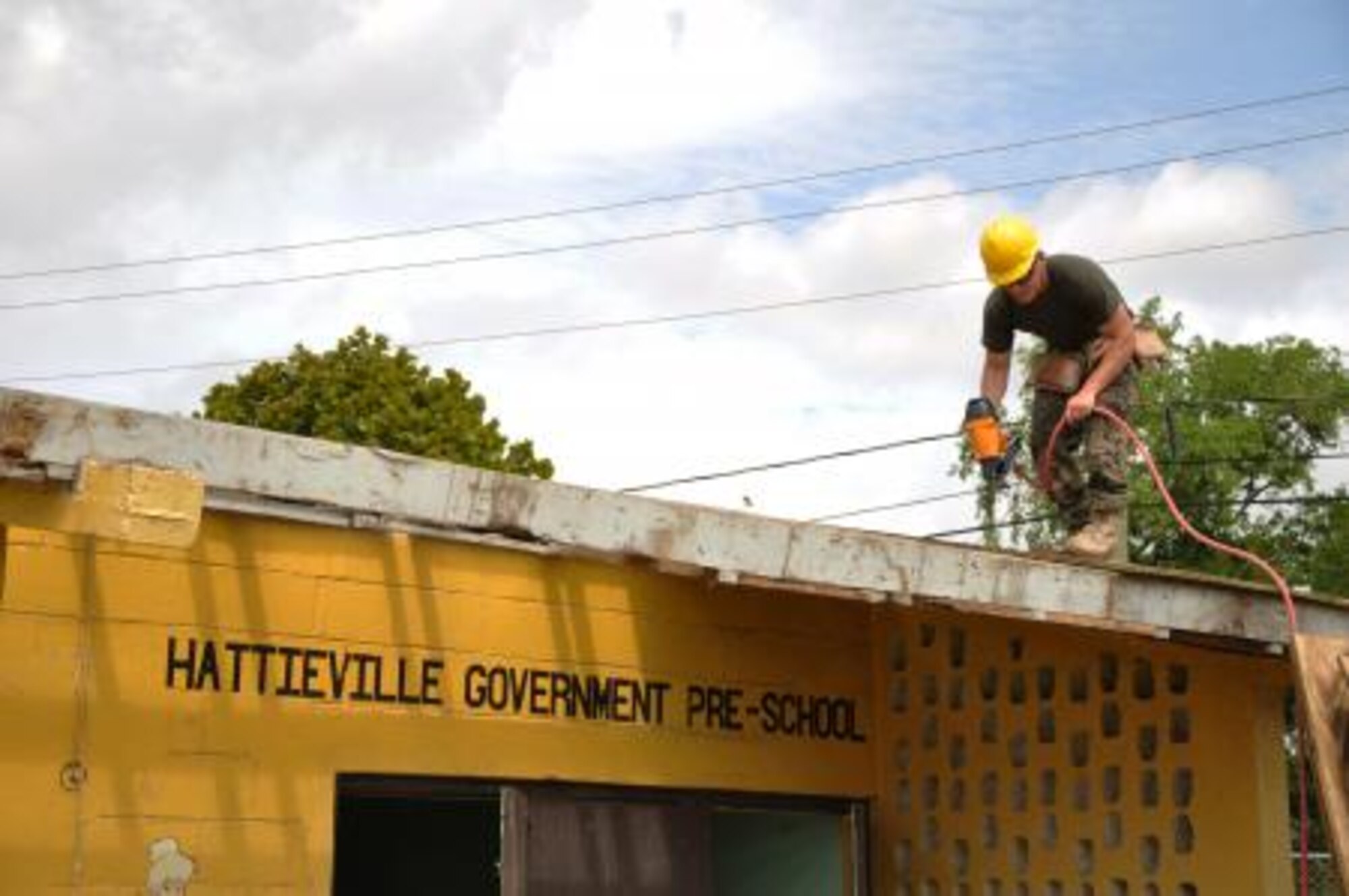 U.S. Marine Corps Cpl. Brett Harden, combat engineer from the Marine Wing Support Squadron 471, uses a nail gun to install roof decking to repair a roof at Hattieville Government Pre-School June 4, 2013, as part of an exercise called New Horizons. Using excess building materials, the civil engineers plan to repair the leaky roof. Civil Engineers from both the U.S. and Belize are constructing various structures at schools throughout Belize as part of an exercise called New Horizons. Building these facilities will support further education for the children of the country and provide valuable training for U.S. and Belizean service members. (U.S. Air Force photo/Capt. Holly Hess)
