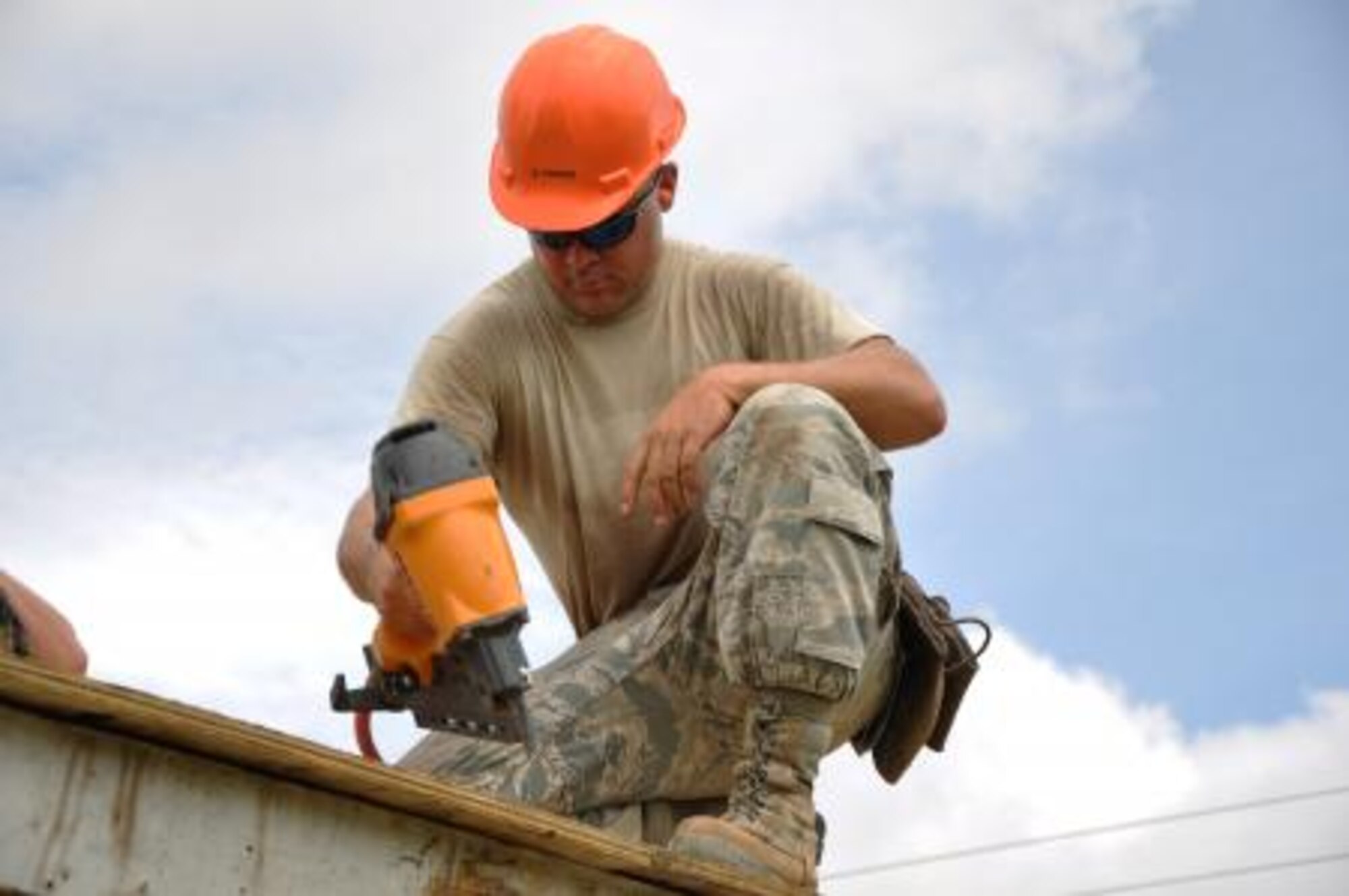 U.S. Air Force Staff Sgt. John McAllister, structures craft lead for Crooked Tree Government Primary School from the 823rd RED HORSE Squadron, uses a nail gun to install roof decking to repair a roof at Hattieville Government Pre-School June 4, 2013, as part of an exercise called New Horizons. Using excess building materials, the civil engineers plan to repair the leaky roof. Civil Engineers from both the U.S. and Belize are constructing various structures at schools throughout Belize as part of an exercise called New Horizons. Building these facilities will support further education for the children of the country and provide valuable training for U.S. and Belizean service members. (U.S. Air Force photo/Capt. Holly Hess)
