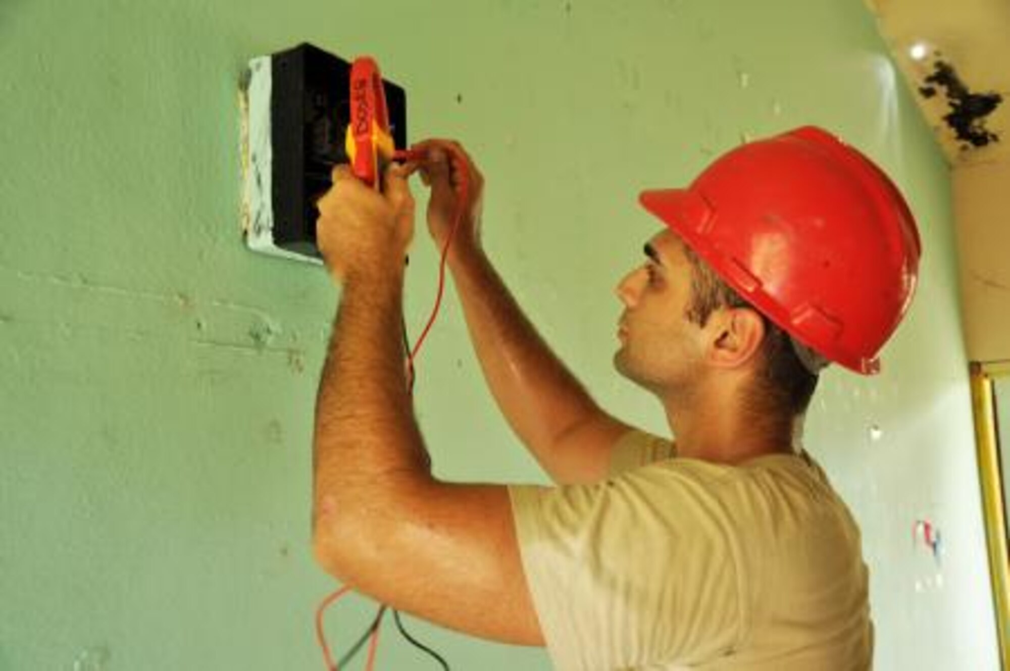 U.S. Air Force Staff Sgt. Serkan Acar, electrician from the 823rd RED HORSE Squadron, troubleshoots the electrical system of Hattieville Government Pre-School June 4, 2013, as part of an exercise called New Horizons. Using excess building materials, civil engineers plan to repair the leaky roof of the school. Civil Engineers from both the U.S. and Belize are constructing various structures at schools throughout Belize as part of an exercise called New Horizons. Building these facilities will support further education for the children of the country and provide valuable training for U.S. and Belizean service members. (U.S. Air Force photo/Capt. Holly Hess)