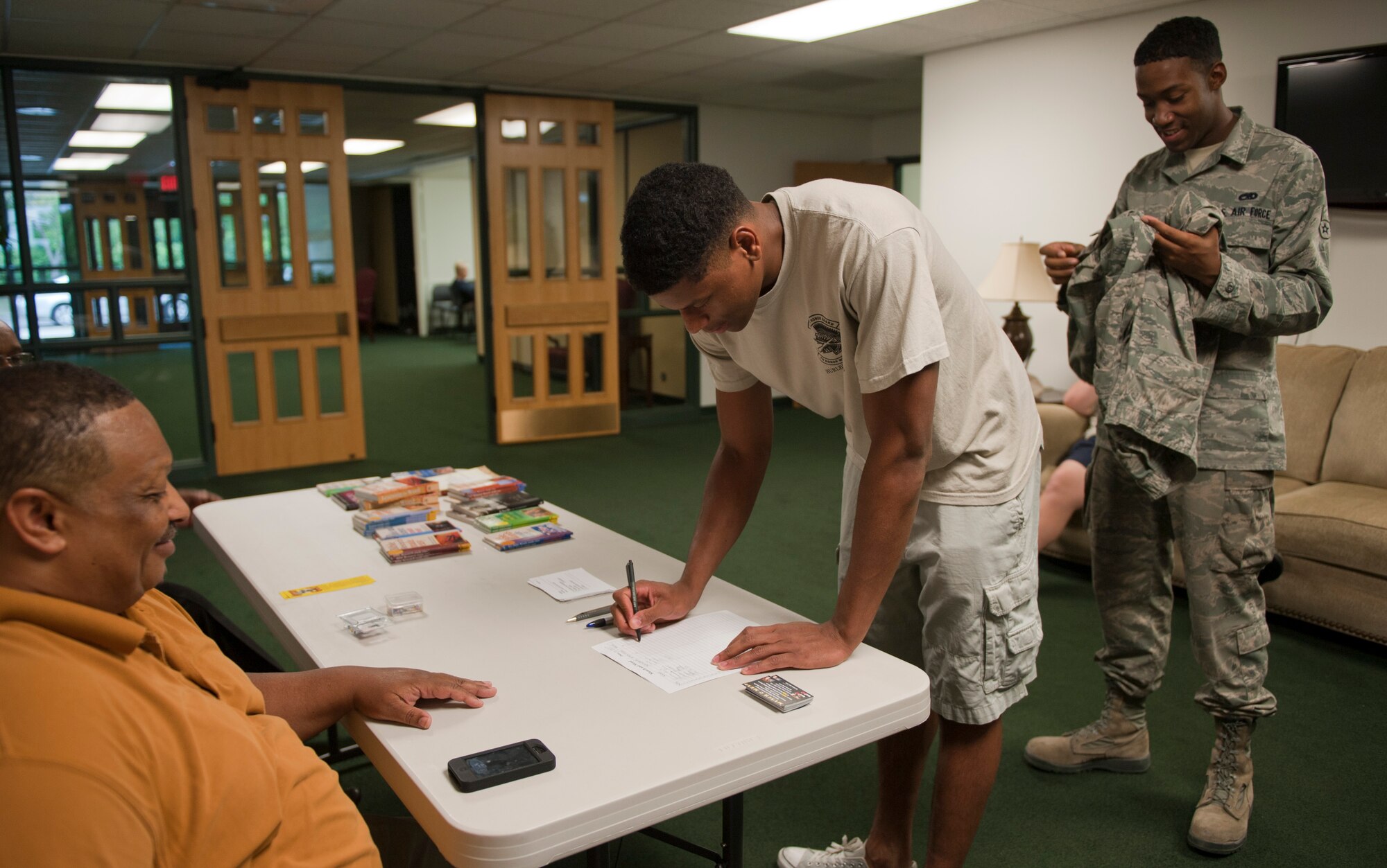 Airmen sign in for Munch and Mend at the chapel on Hurlburt Field, Fla., June 10, 2013. Munch and Mend is a program in which Airmen and civilian personnel can eat a free meal while waiting for their clothing to be sewn. The program is offered every second Monday of each month from 5 to 7 p.m. (U.S. Air Force photo by Senior Airman Krystal M. Garrett) 