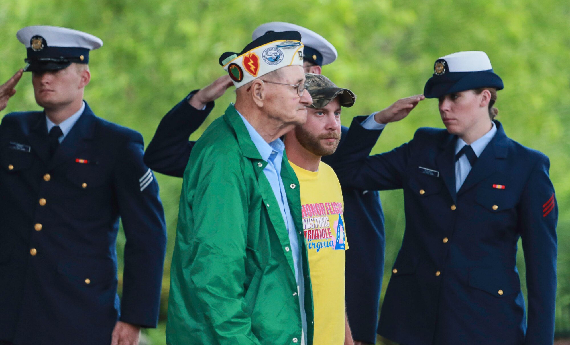 World War II veterans are saluted during a receiving line at Washington, D.C., June 8, 2013. As part of the Honor Flight program, the veterans were taken to see the World War II Memorial, as well as Arlington National Cemetery, the Marine Corps War Memorial, Korean War and Vietnam War Memorials.  (Courtesy photo by U.S. Air Force Master Sgt. Kevin Ferrara)