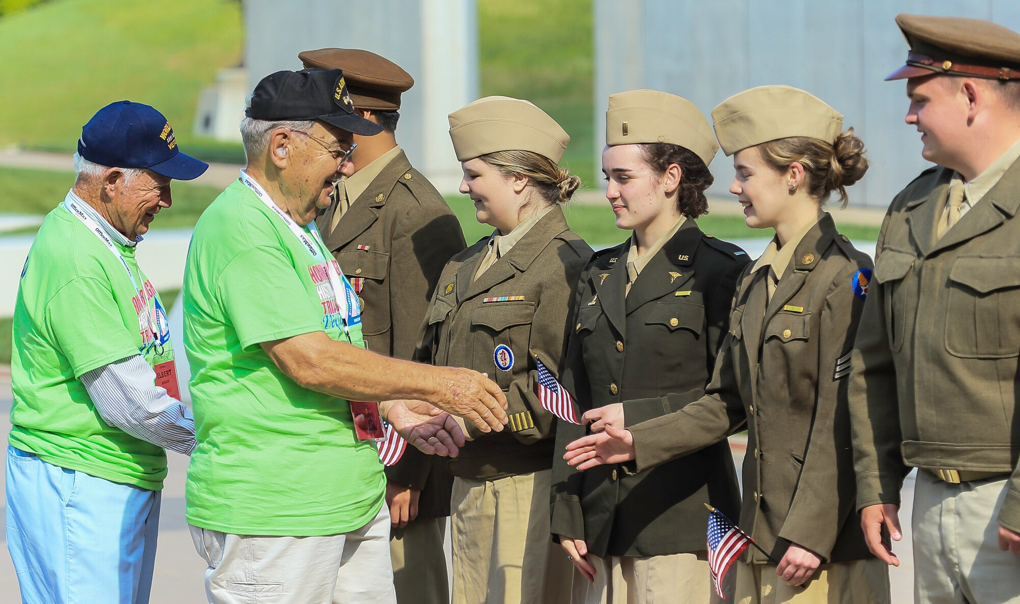 A group of World War II re-enactors greet veterans during an Honor Flight trip to Washington, D.C., June 8, 2013. The Honor Flight program began in May 2005 and now has 128 regional non-profit Honor Flight organizations that participate in the program. (Courtesy photo by U.S. Air Force Master Sgt. Kevin Ferrara)