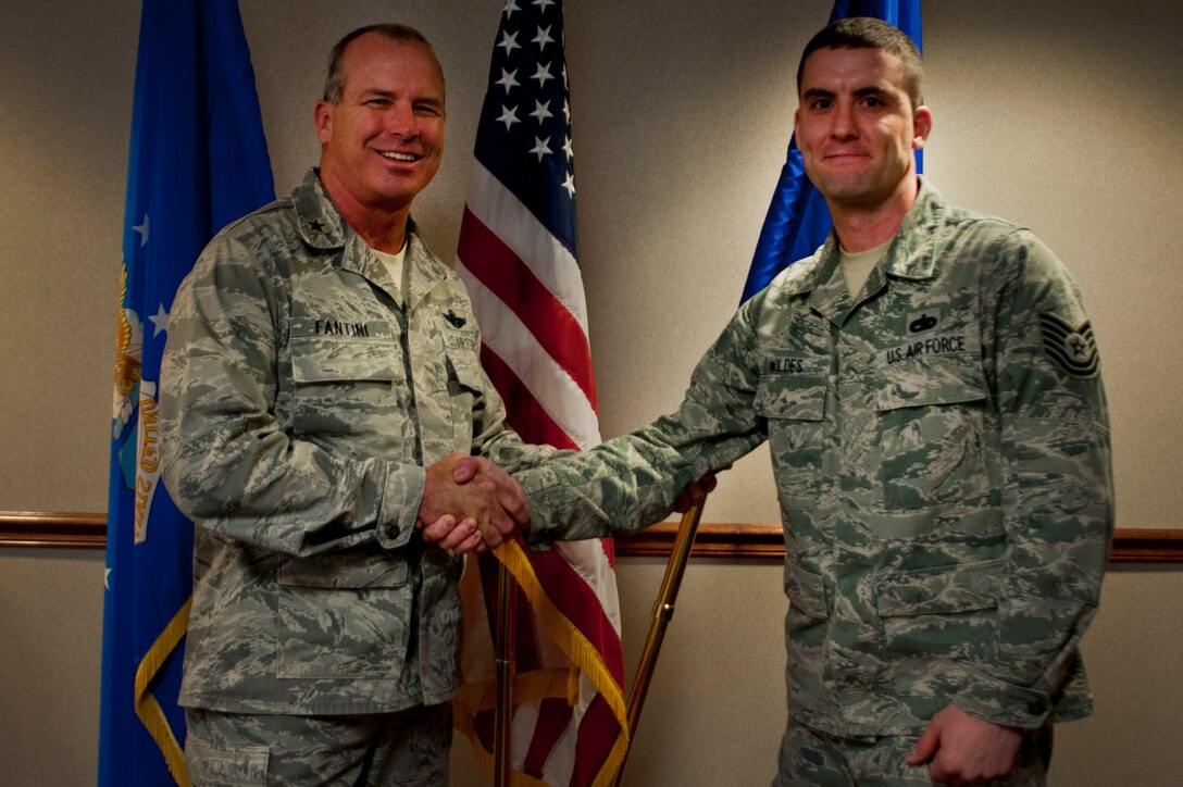 Brig. Gen. Michael Fantini, 82nd Training Wing commander, congratulates Tech. Sgt. Andrew Wildes , 361st Training Squadron aerospace propulsion instructor supervisor, for being selected as the commander's Wingman of Choice award recipient in the 82nd Training Wing conference room.  He was selected for the impact he is making on a daily basis with his fellow instructors and the Airmen in training they teach. Wildes is also the associate first sergeant for the squadron. (U.S. Air Force photo/Staff Sgt. Mike Meares/Released)